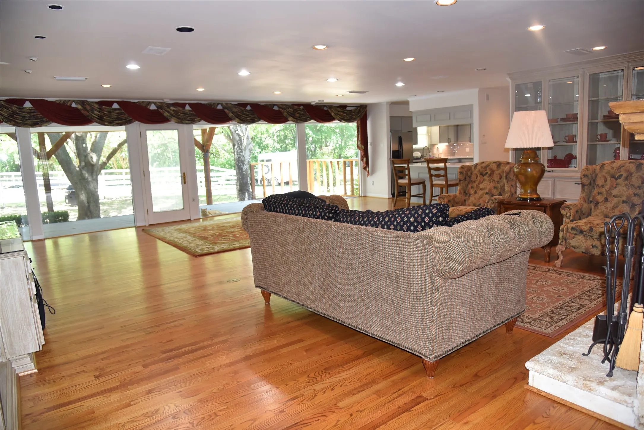 Expansive living area featuring wood-finish flooring and recessed lighting