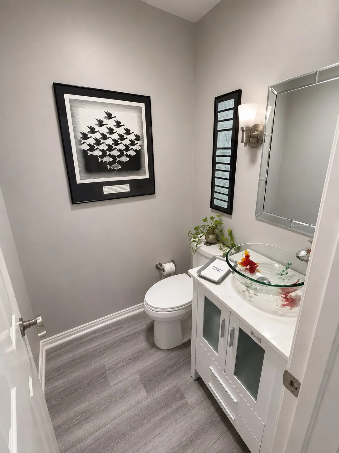 Contemporary vanity with a glass vessel sink, sleek mirror, and brushed nickel wall sconce
