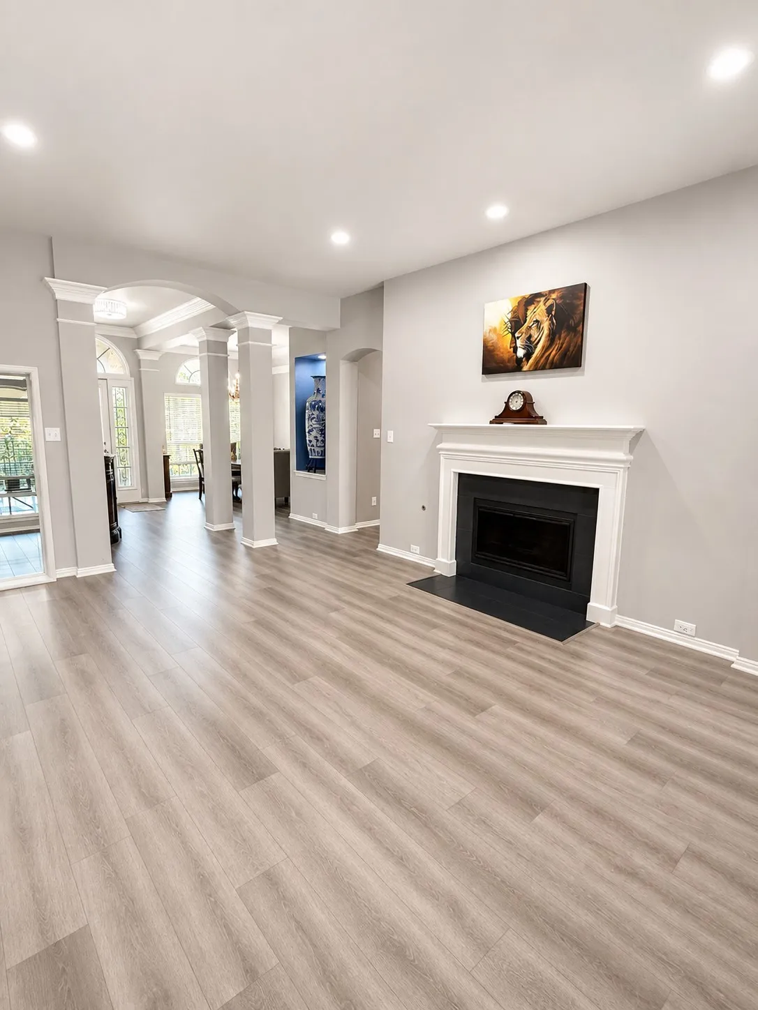 Recessed lighting illuminates wood-finish flooring