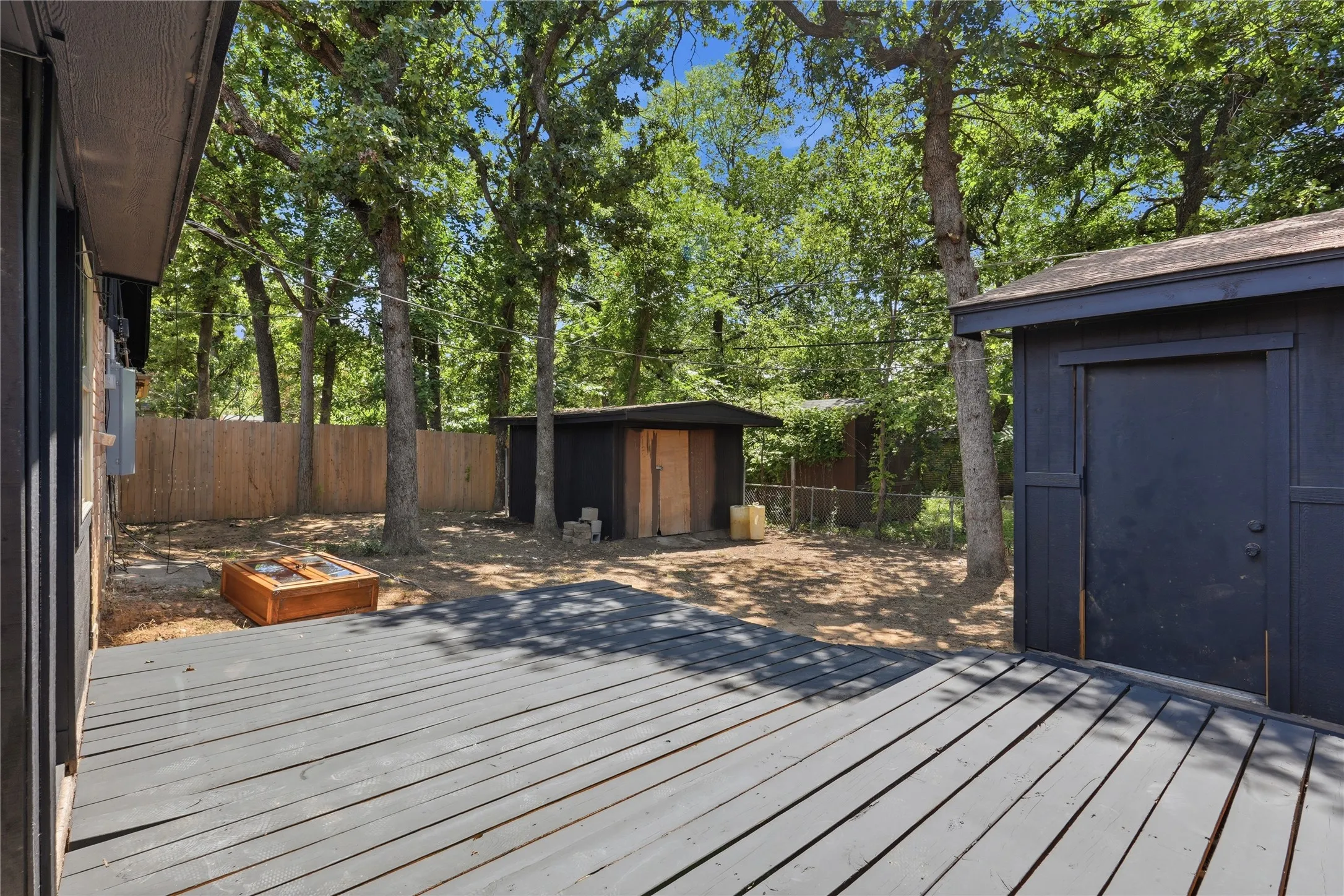 Expansive outdoor decking features a dark finish and provides a large area for outdoor enjoyment