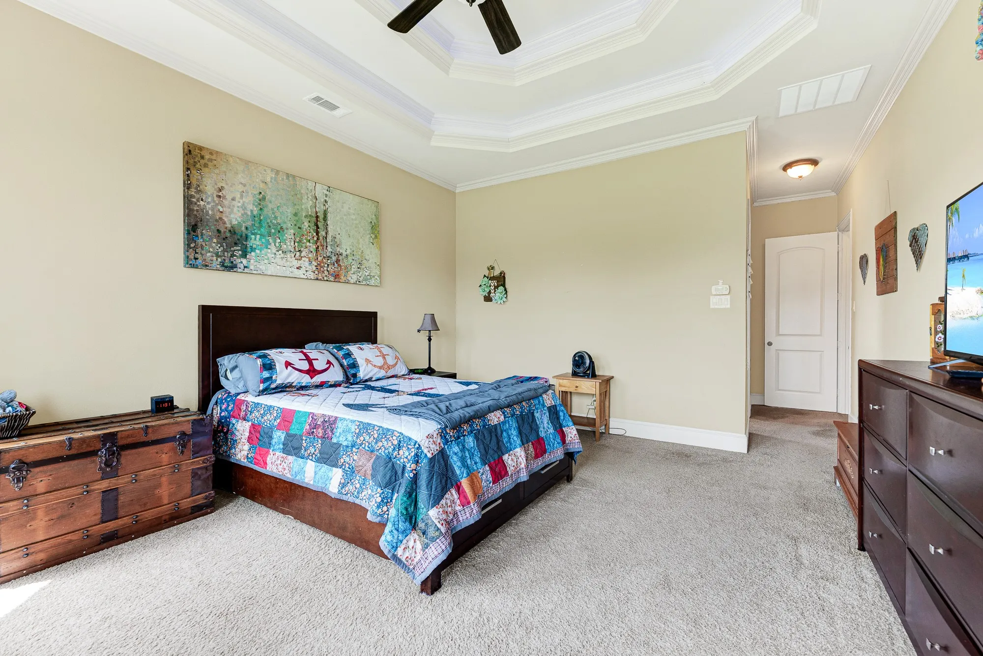 A grand, octagonal tray ceiling with detailed multi-layered trim enhances the room’s open and airy architectural scale. It is a wonderfully calming sanctuary to slip into at the end of a busy day, wrapping you in total comfort.