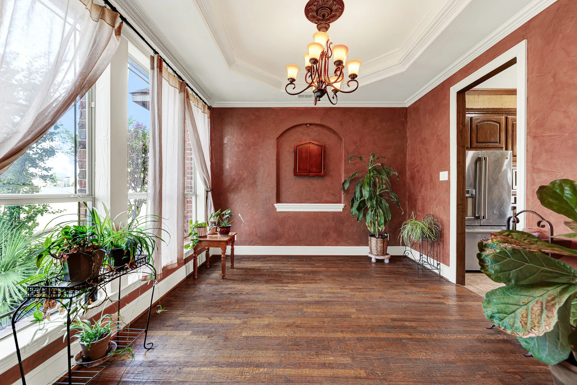 A deep, arched wall niche serves as a captivating focal point against the warm, textured plaster finish. Imagine setting a beautifully styled buffet underneath it, ready to spark effortless conversation during a lively holiday gathering.