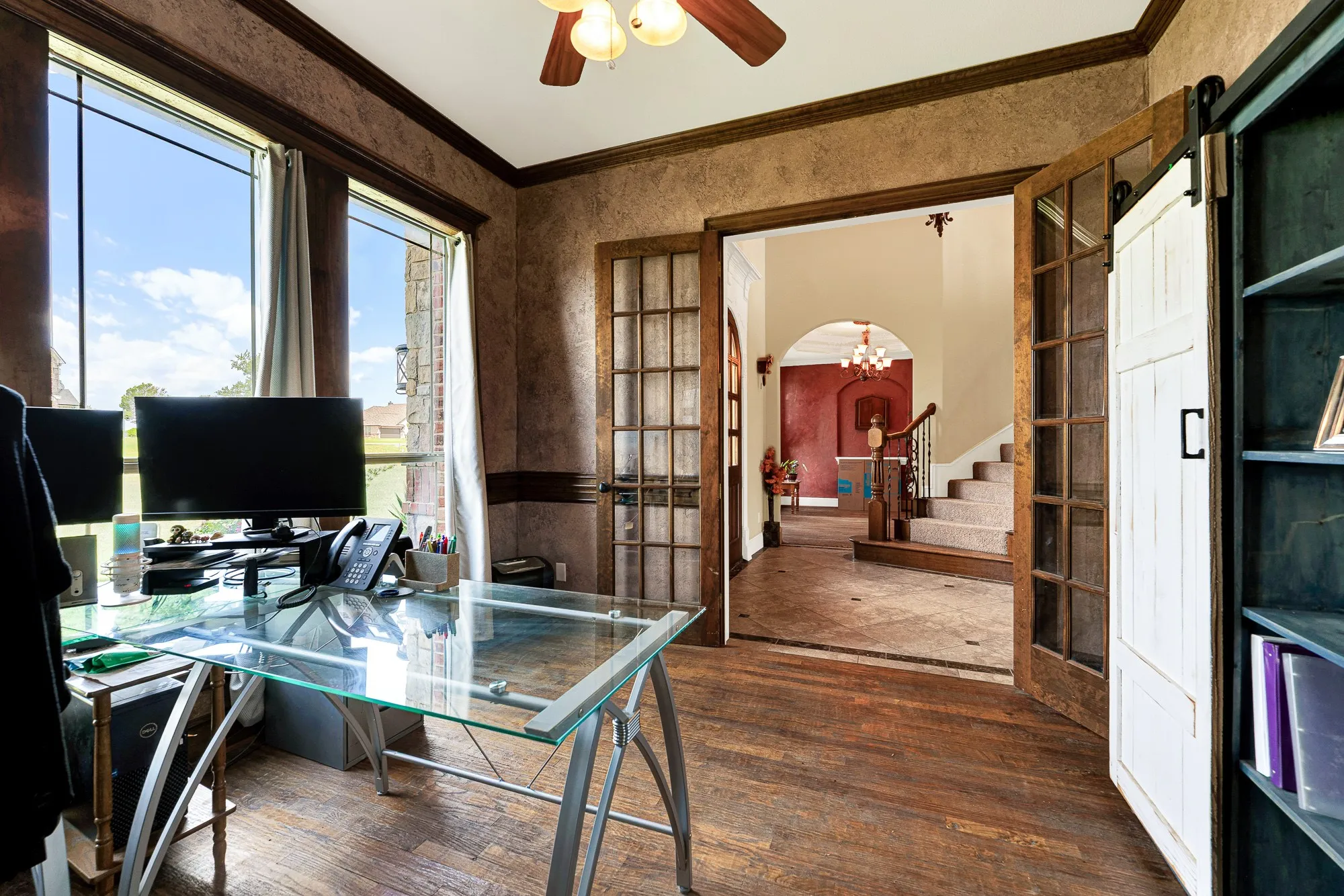 Classic double French doors frame a beautiful sightline into the main hall, perfectly balancing privacy with an open flow. You can easily close yourself off for a focused afternoon call while still feeling connected to the home's gentle rhythm.