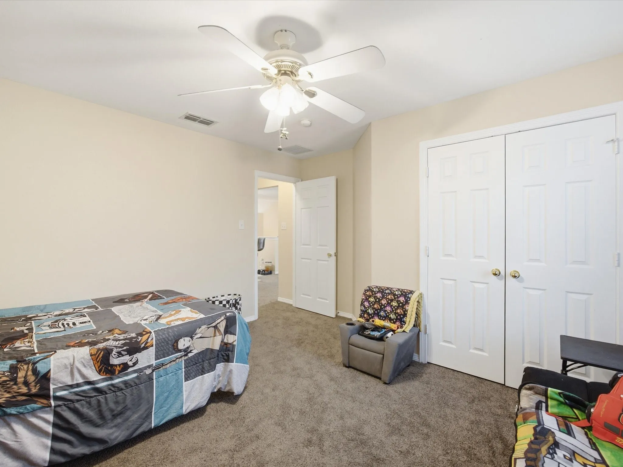 Neutral-toned walls complement the gray carpeting