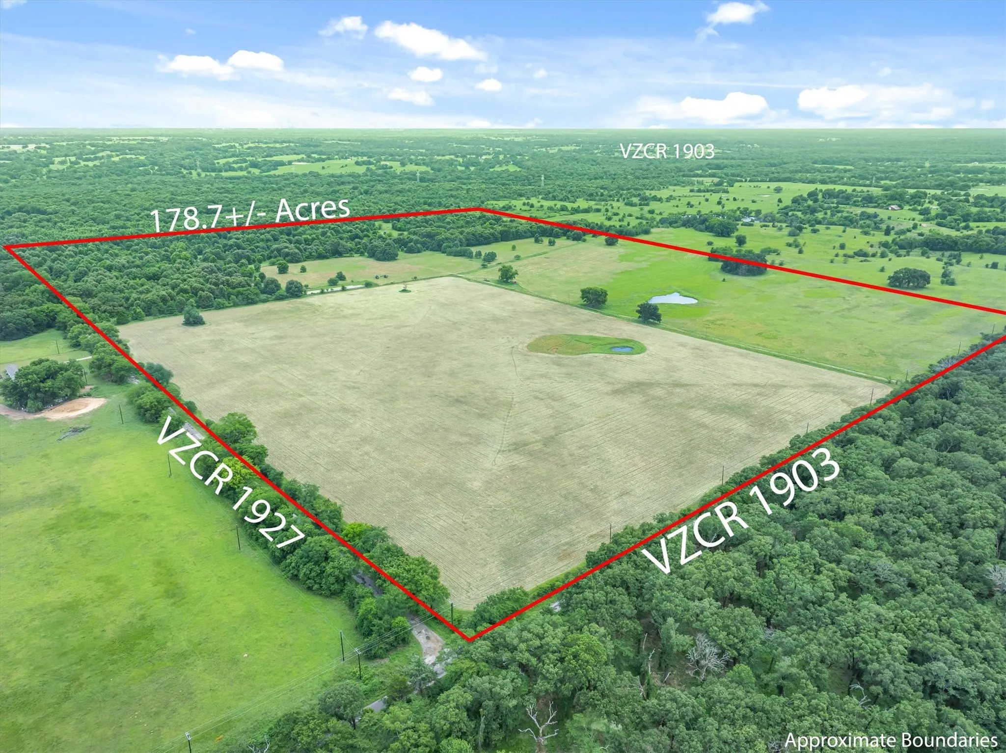 Expansive 178.7+/- acre land parcel featuring a large cleared field area, two visible ponds, and surrounding tree lines
