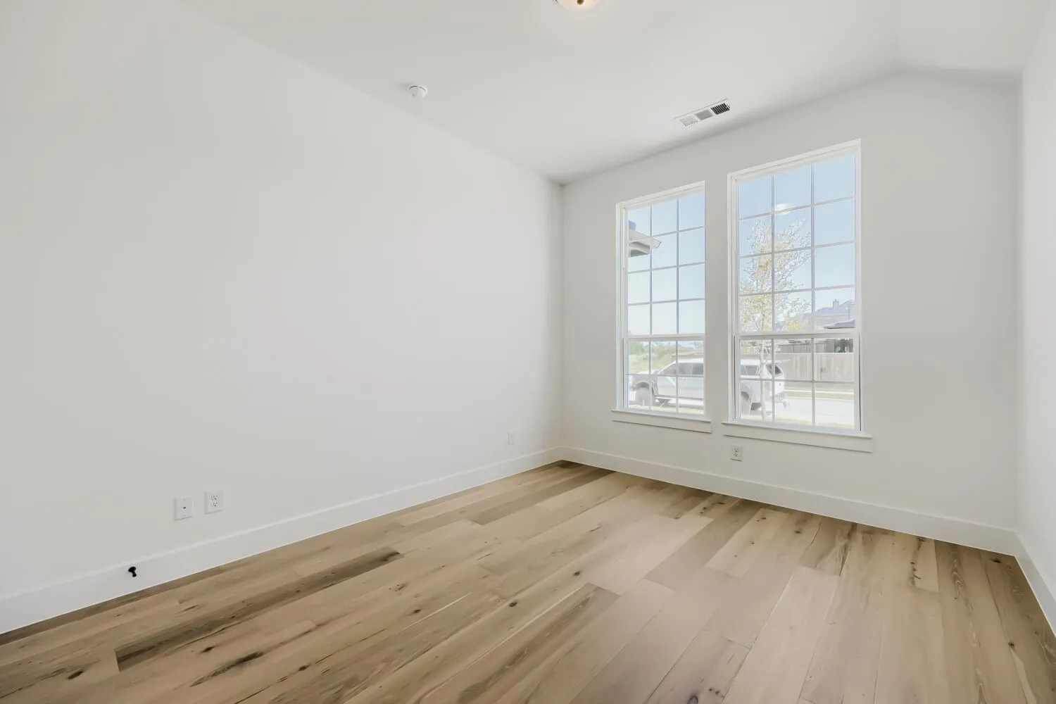 Room featuring light wood-finish flooring and bright white walls