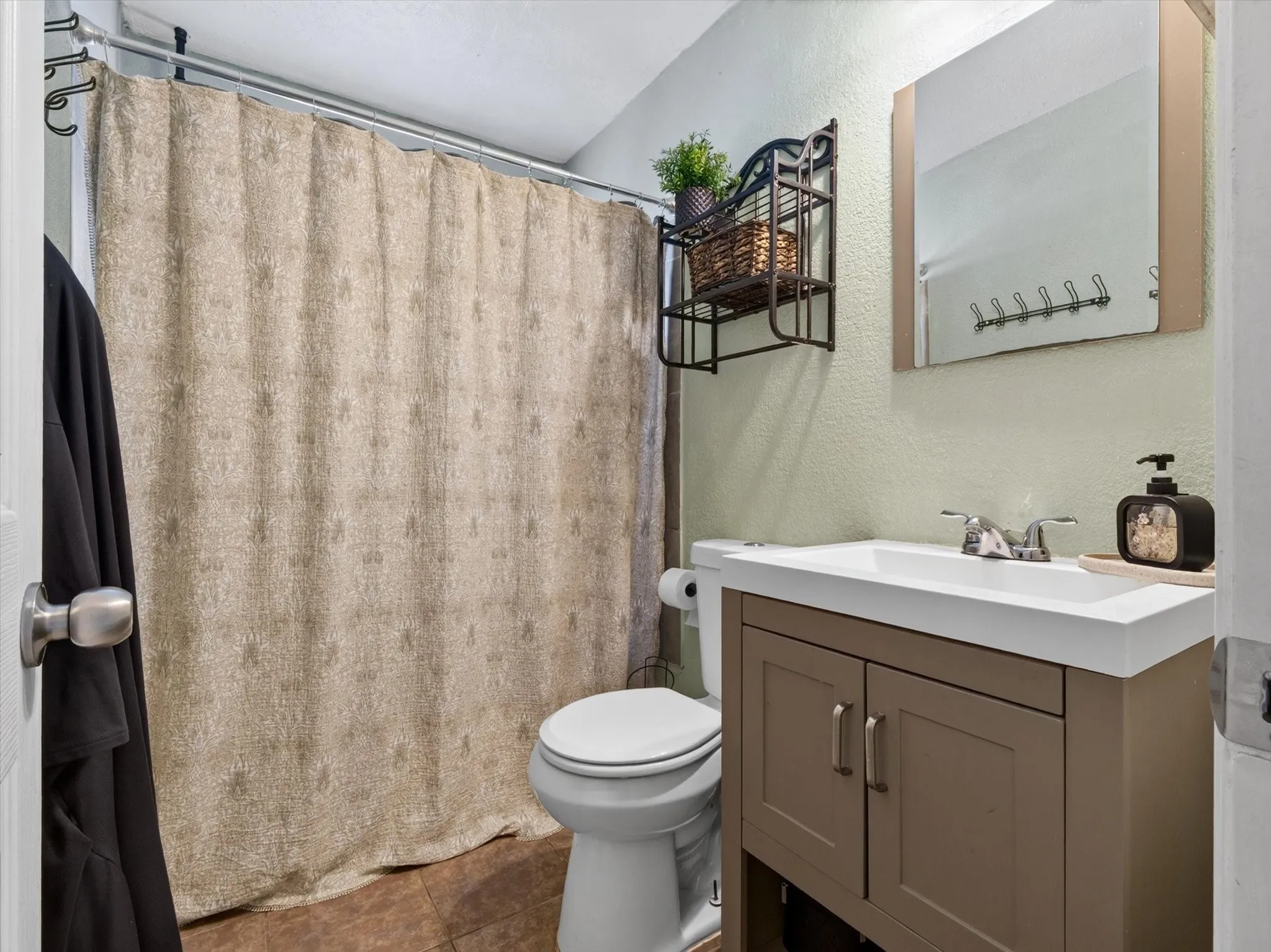 Vanity with an integrated sink, polished chrome faucet, and storage cabinetry