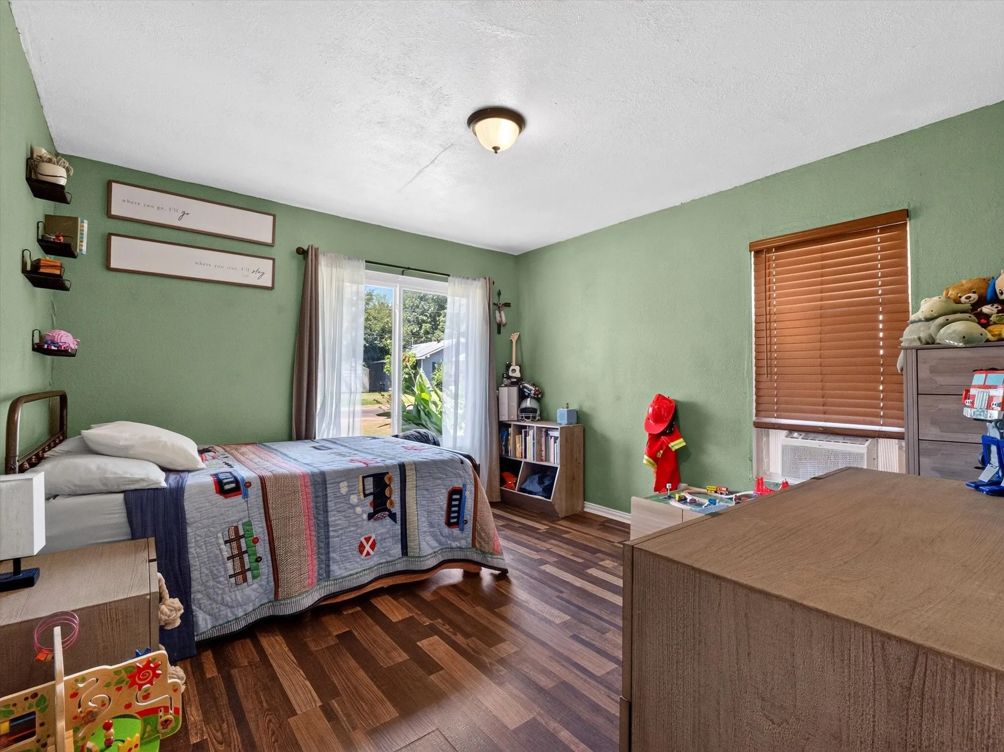 Interior room featuring wood-finish flooring and a single ceiling light fixture