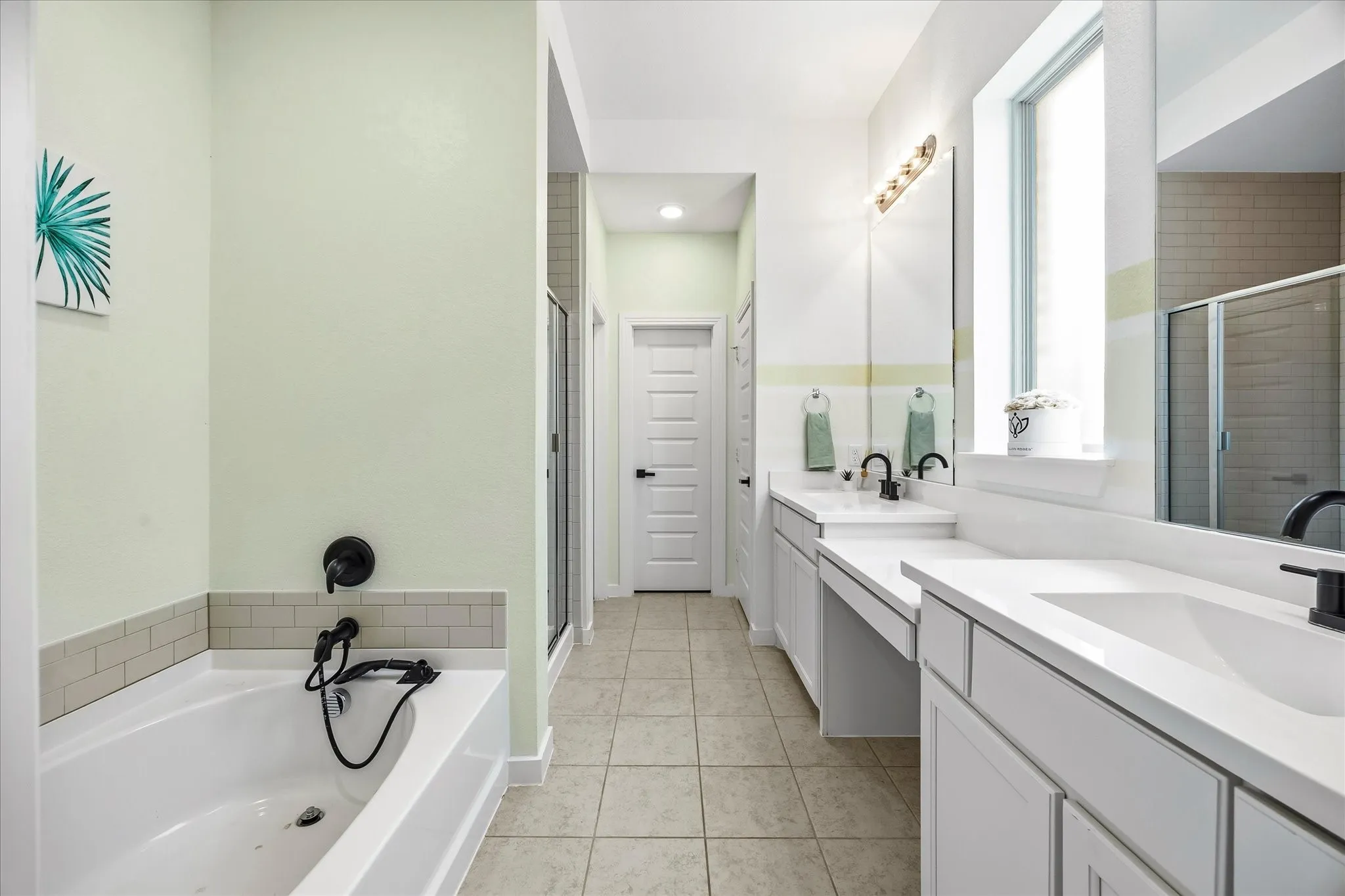 Spa style master bath includes his and her vanities with make up area