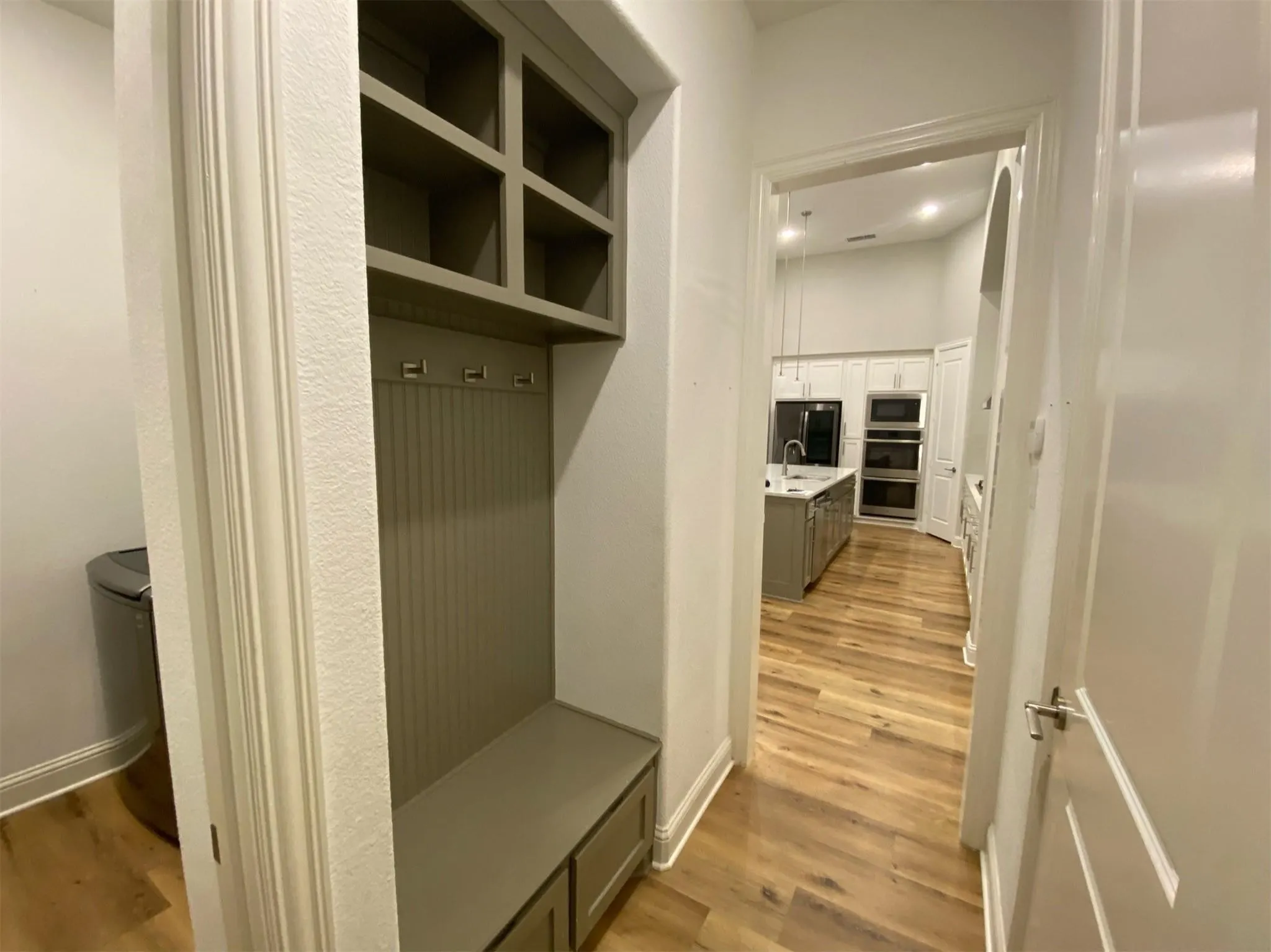 Built-in mudroom bench with cubby storage and coat hooks