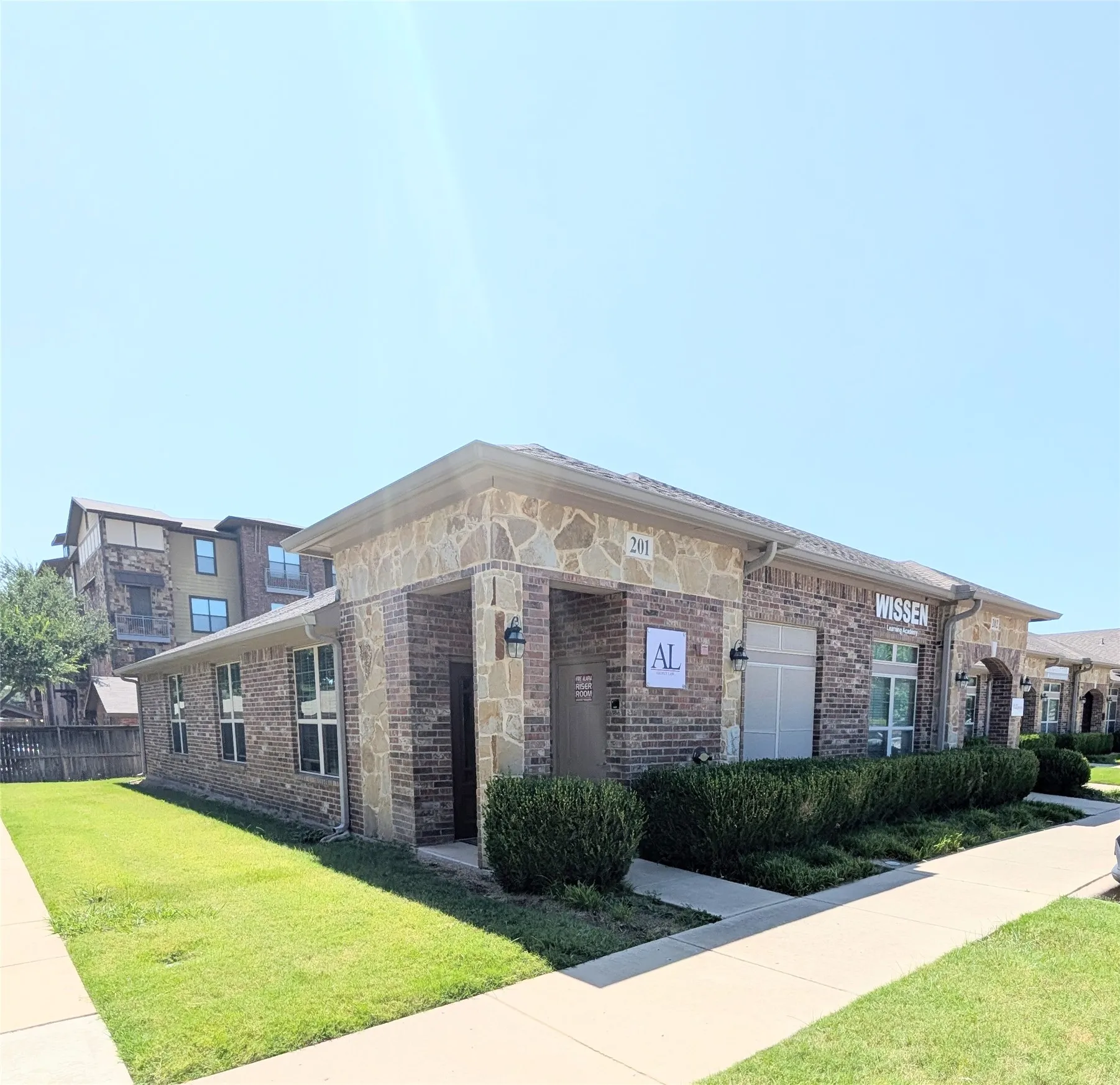 Brick and stone exterior building with multiple windows