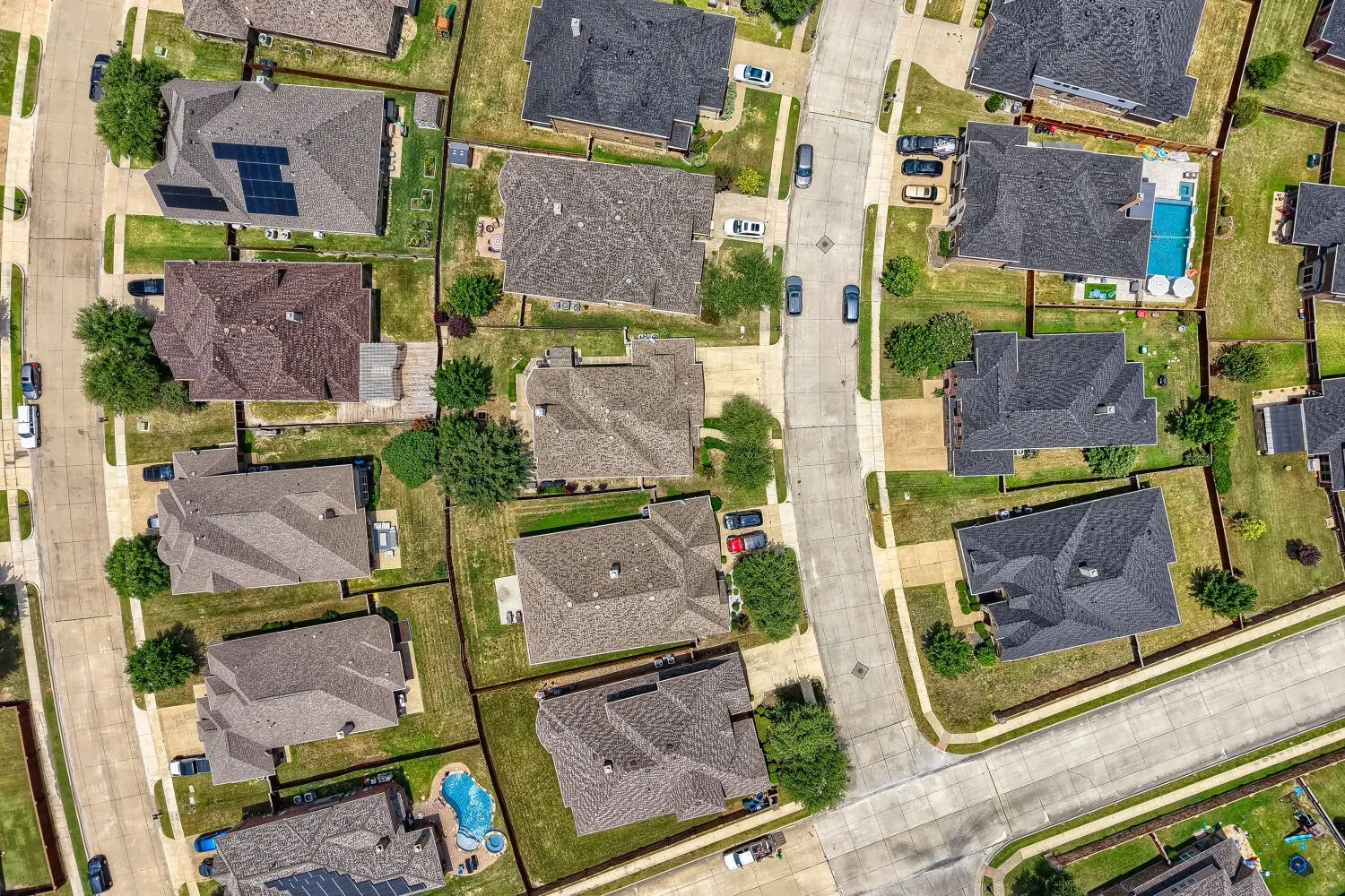 Aerial view of a residential neighborhood with varied architectural styles and landscaping