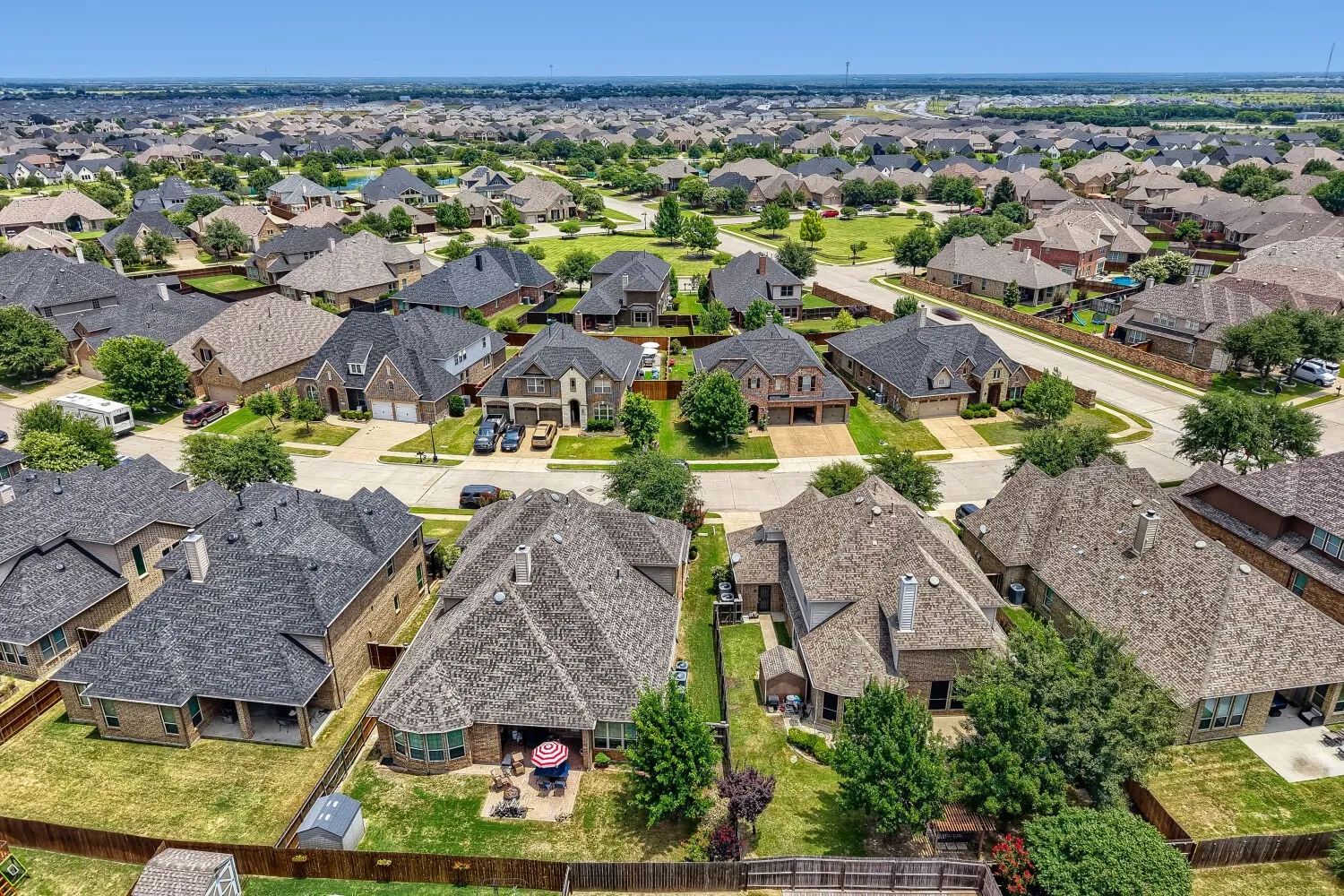 Aerial perspective showcasing an expansive residential neighborhood with numerous single-family homes