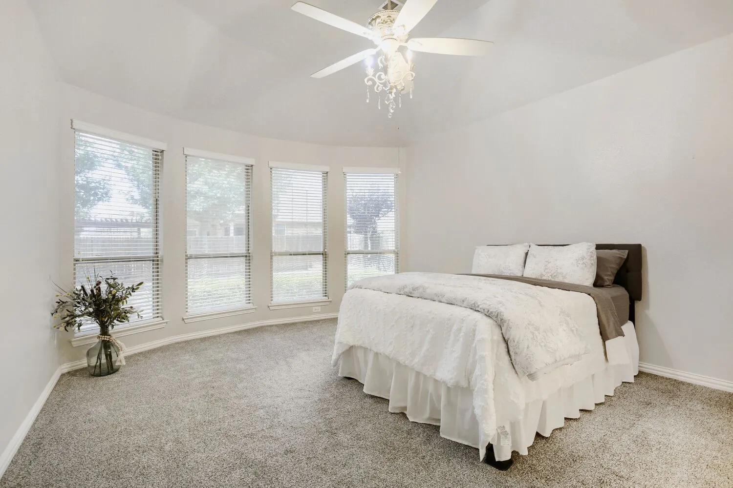 Curved wall with four windows, individual blinds, and white trim