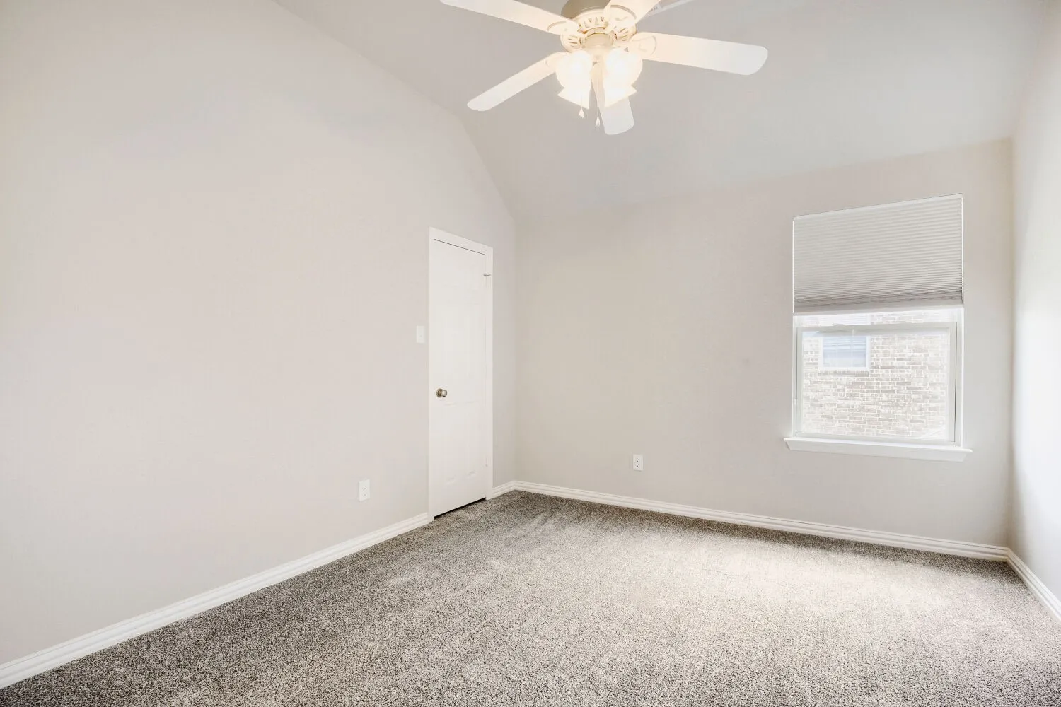 Room featuring a vaulted ceiling, ceiling fan, neutral wall paint, gray carpet flooring, and a single window with blinds