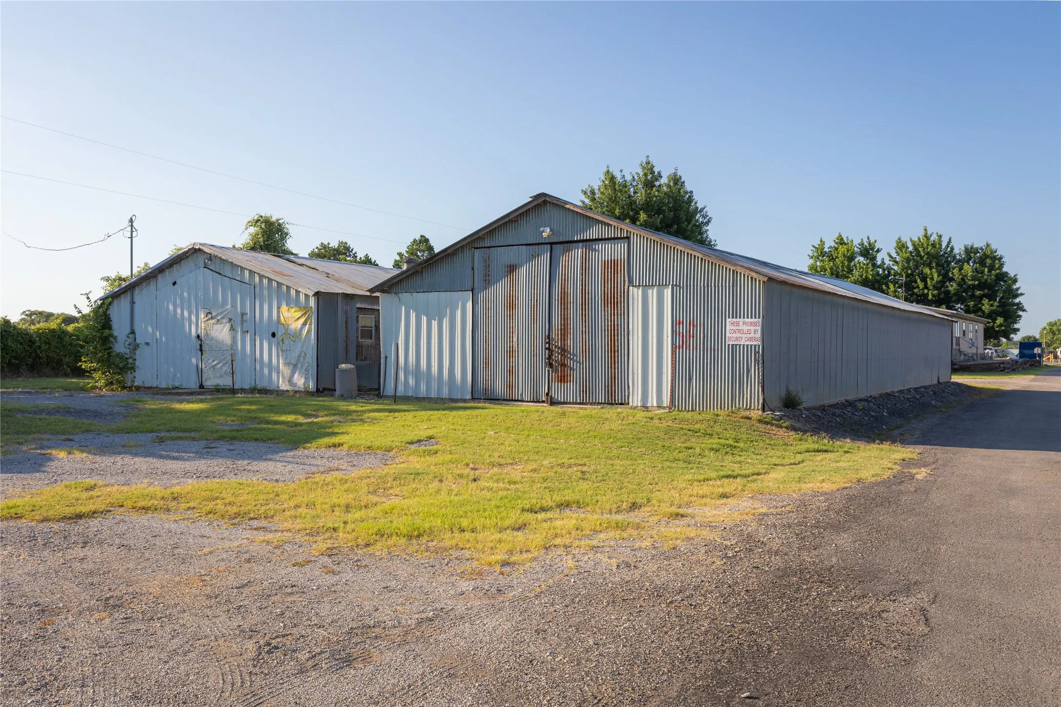 Two corrugated metal buildings with pitched roofs