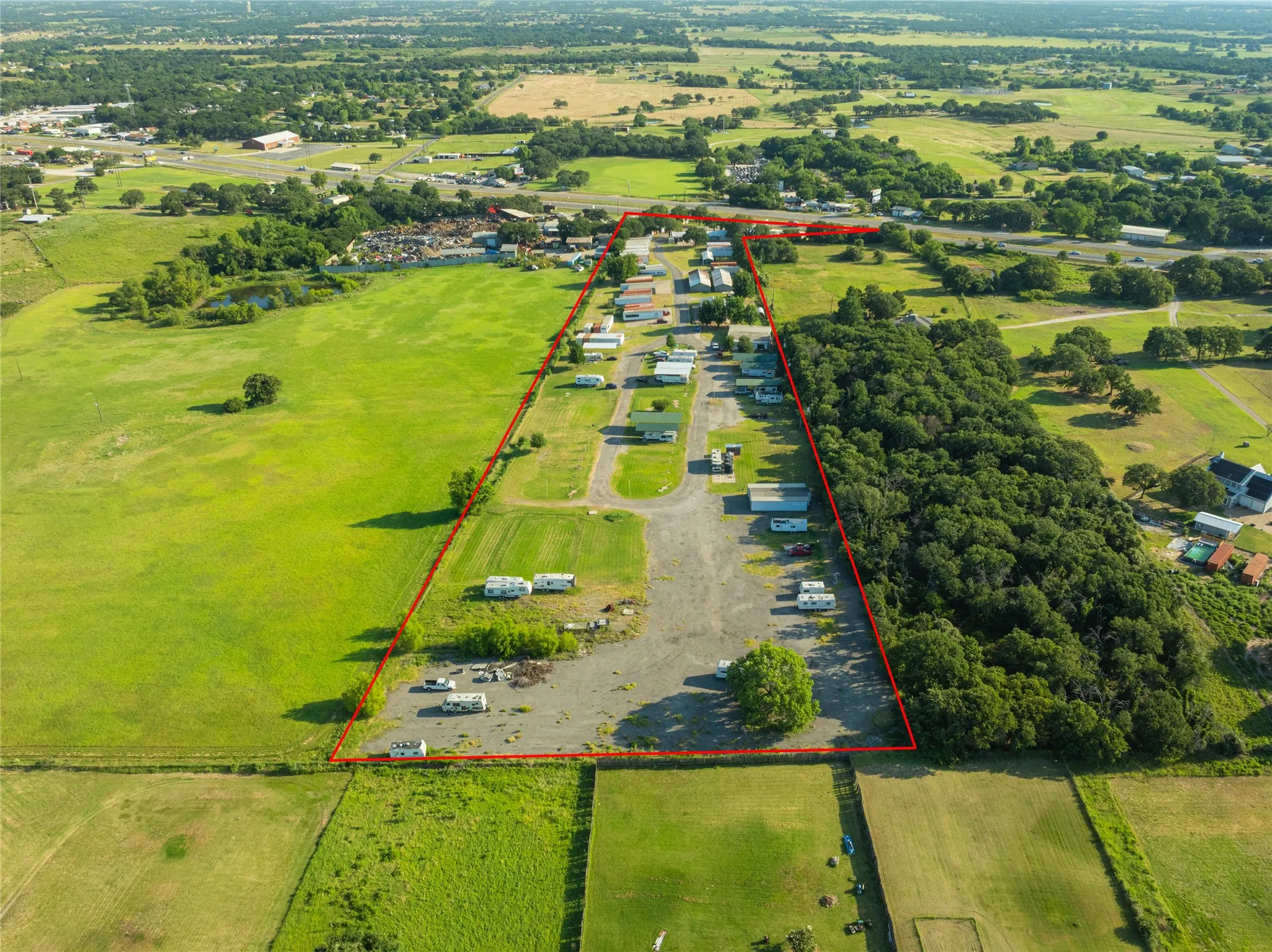 Aerial view of a sprawling property showcasing extensive open land and varied terrain