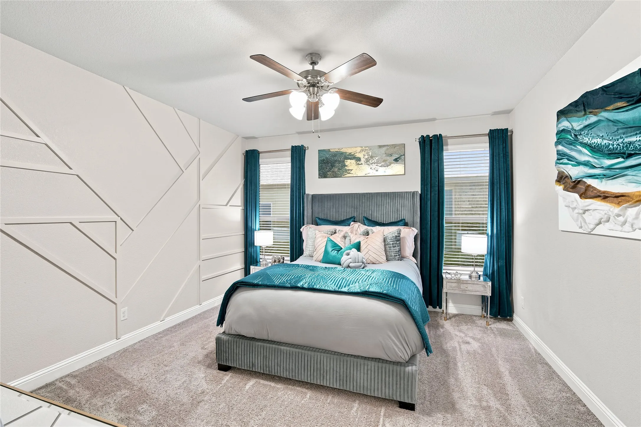 Bedroom featuring a geometric accent wall, ceiling fan with integrated lighting, and two windows with blinds