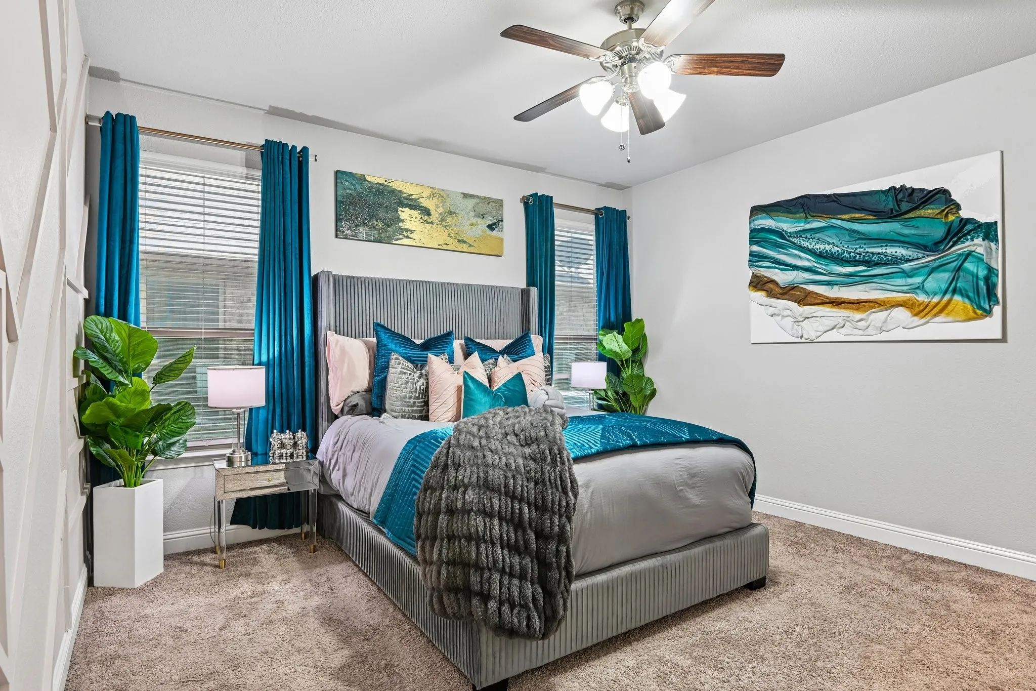 Carpeted room featuring a ceiling fan with integrated lighting, window with blinds, and white baseboards