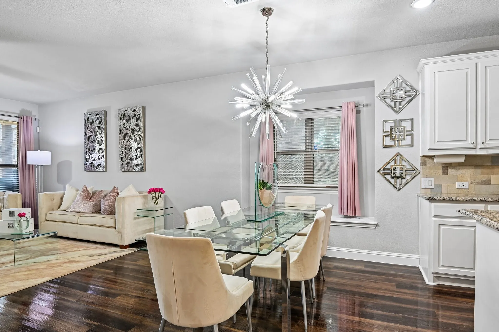 Dining area featuring a contemporary chandelier and dark wood-finish flooring