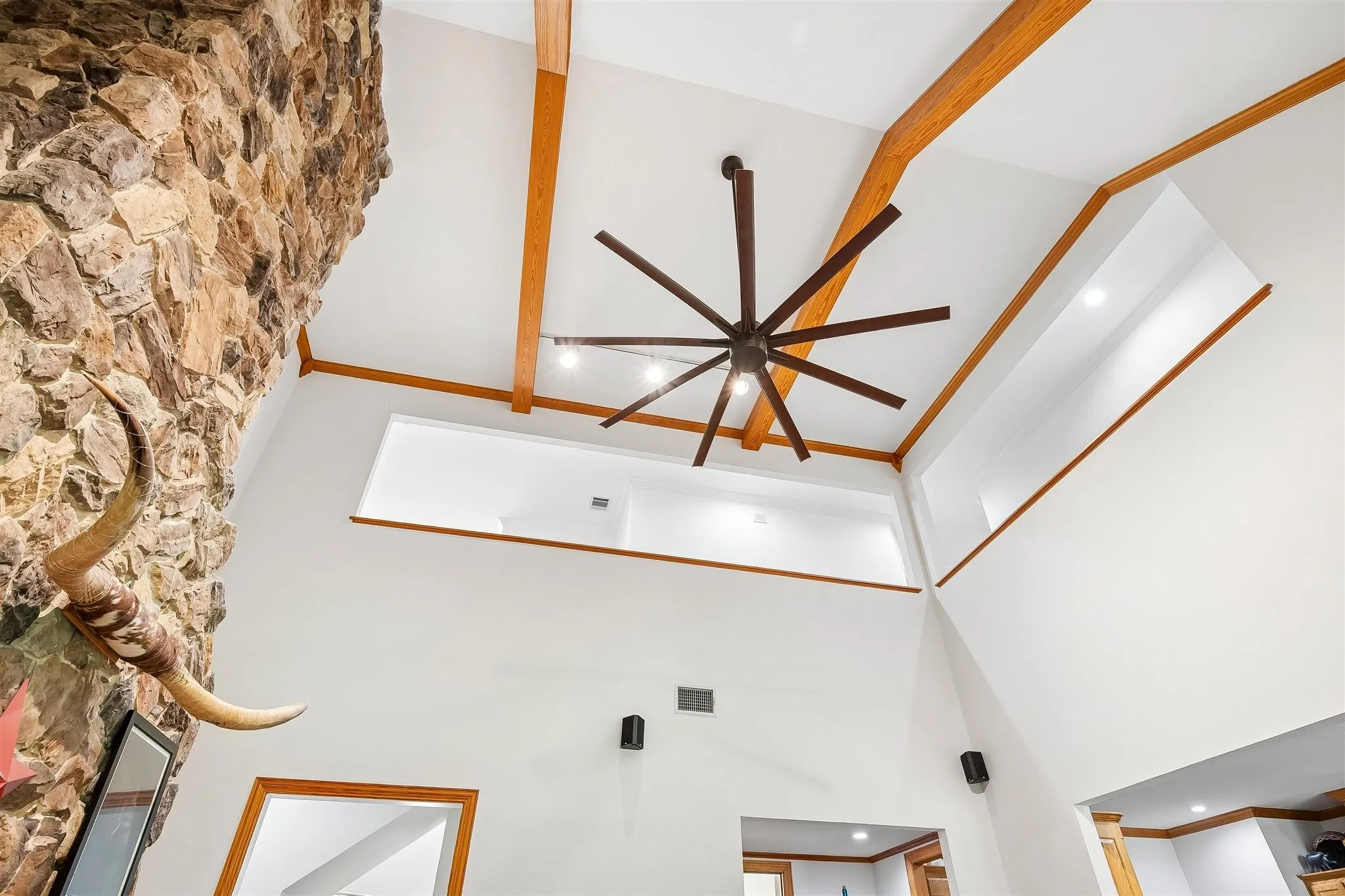 Two-story ceiling with wood beams in main living area