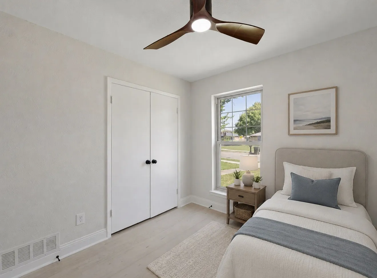Ceiling fan with integrated lighting, wood-finish flooring, and a double-door closet