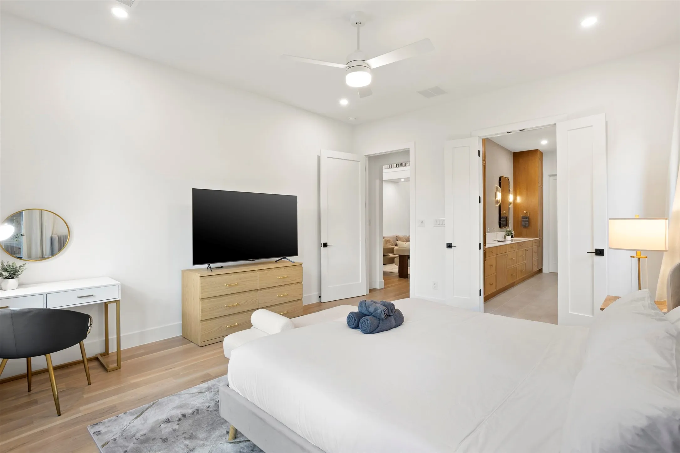 Open concept bedroom with light wood-finish flooring