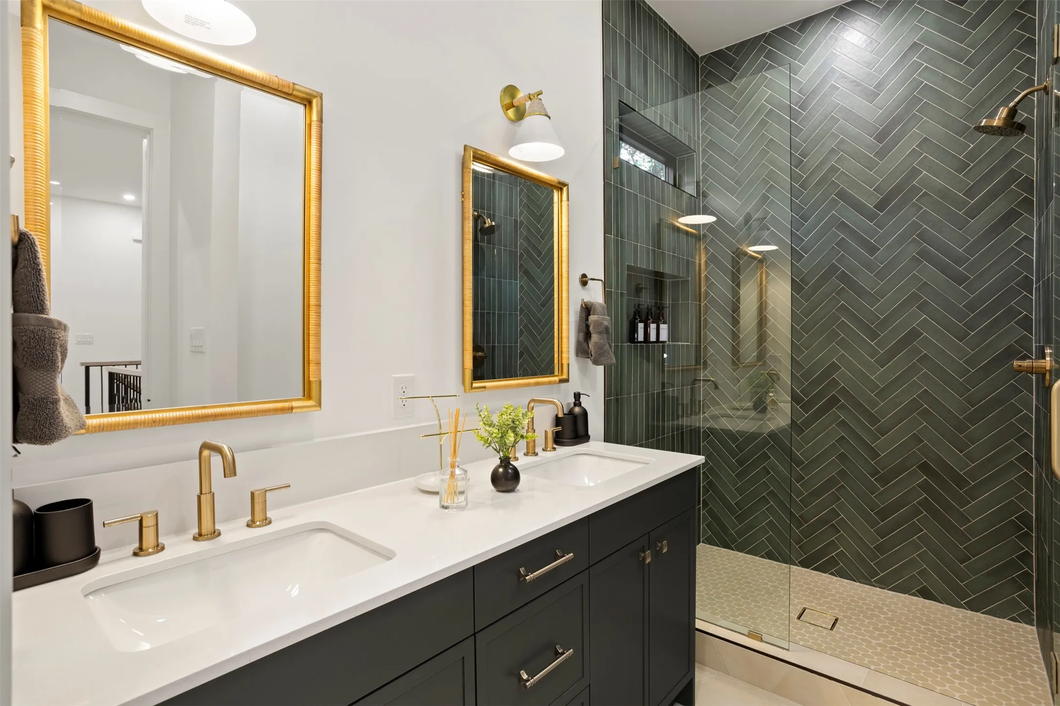 Bathroom featuring a dual vanity with undermount sinks, white countertop, and dark cabinetry
