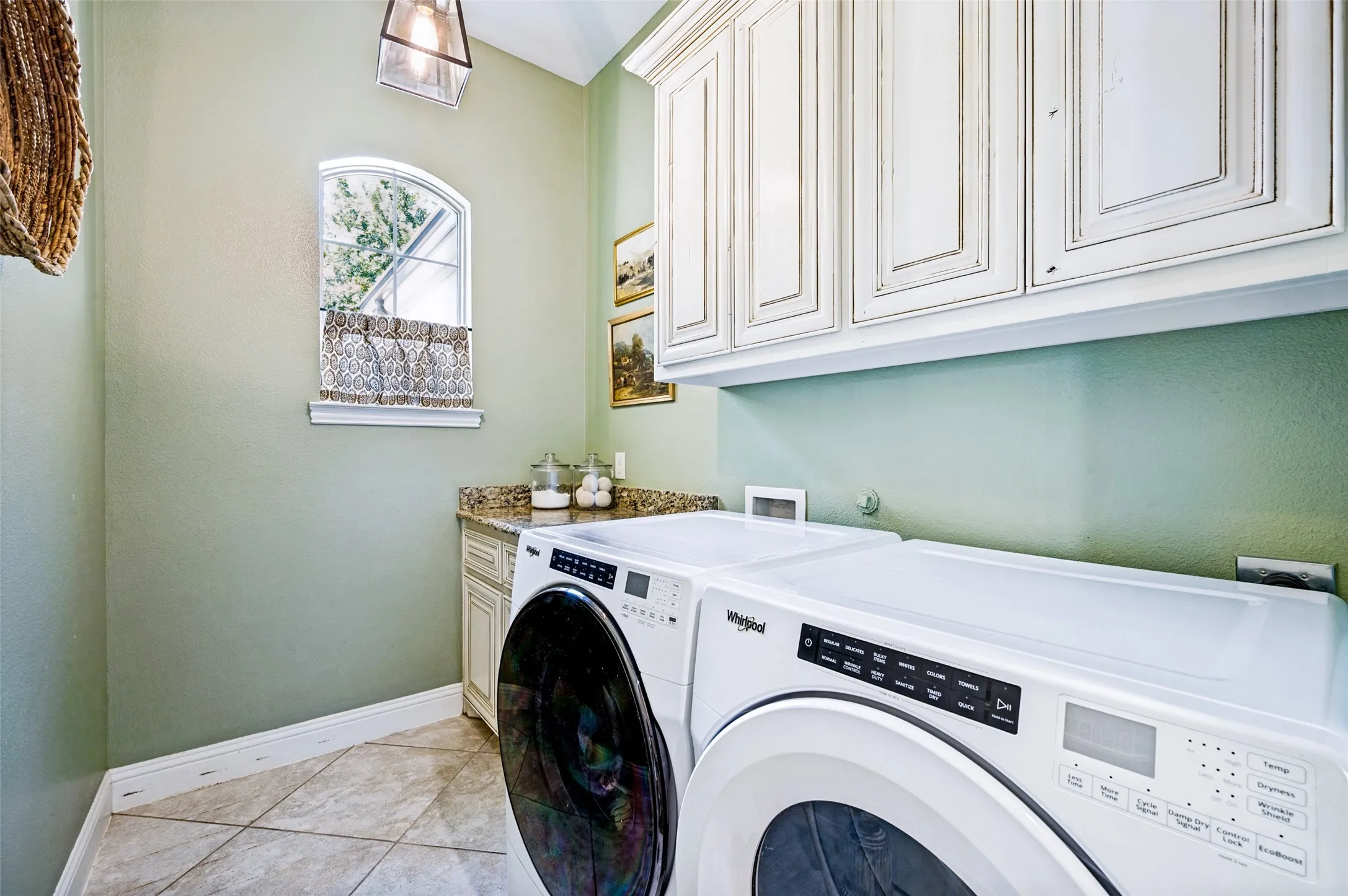 Large laundry room with cabinets and counter space