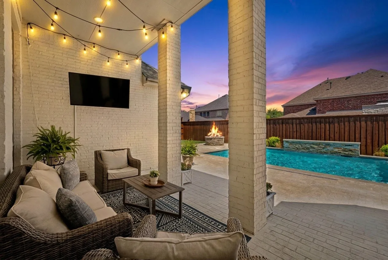 Backyard escape with covered porch, pool and firepit.