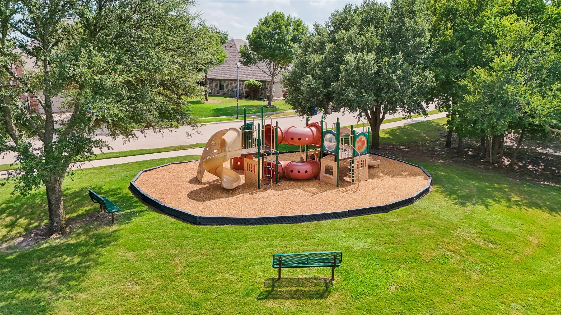 Community playground featuring a multi-level structure with slides and climbing elements