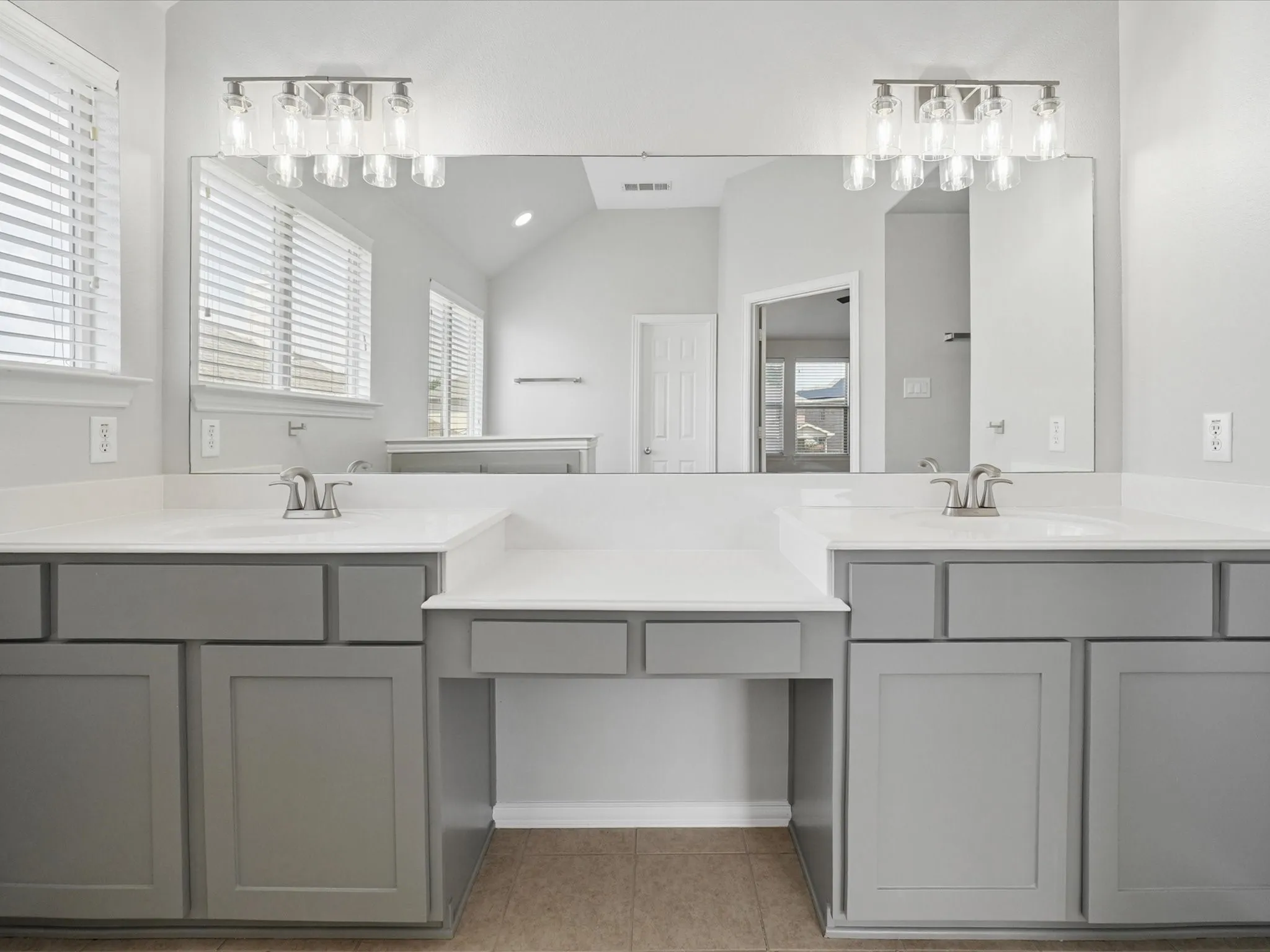 Dual vanity with integrated sinks and white countertops