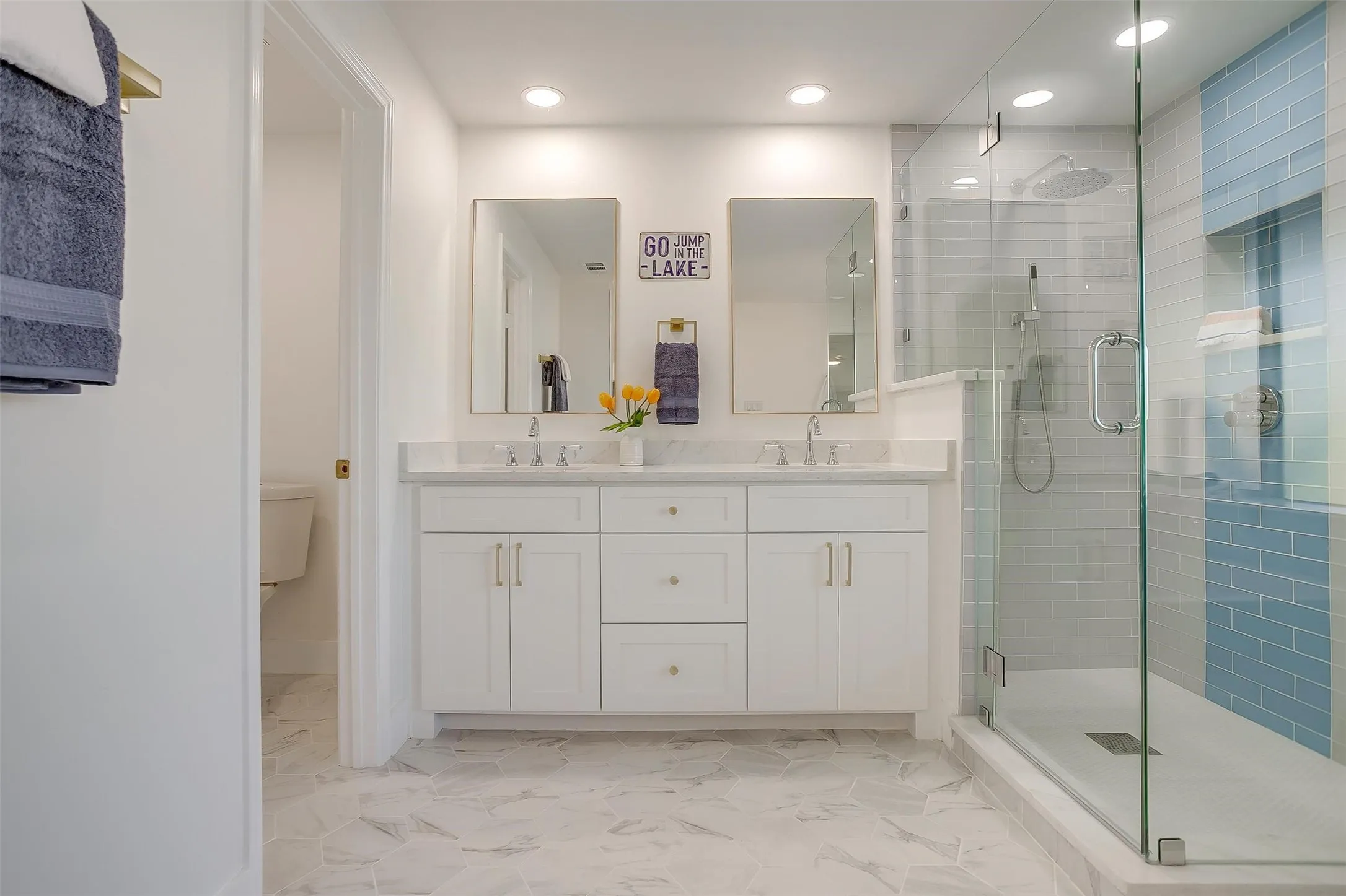 Double vanity with quartz countertop, dual undermount sinks, and individual framed mirrors