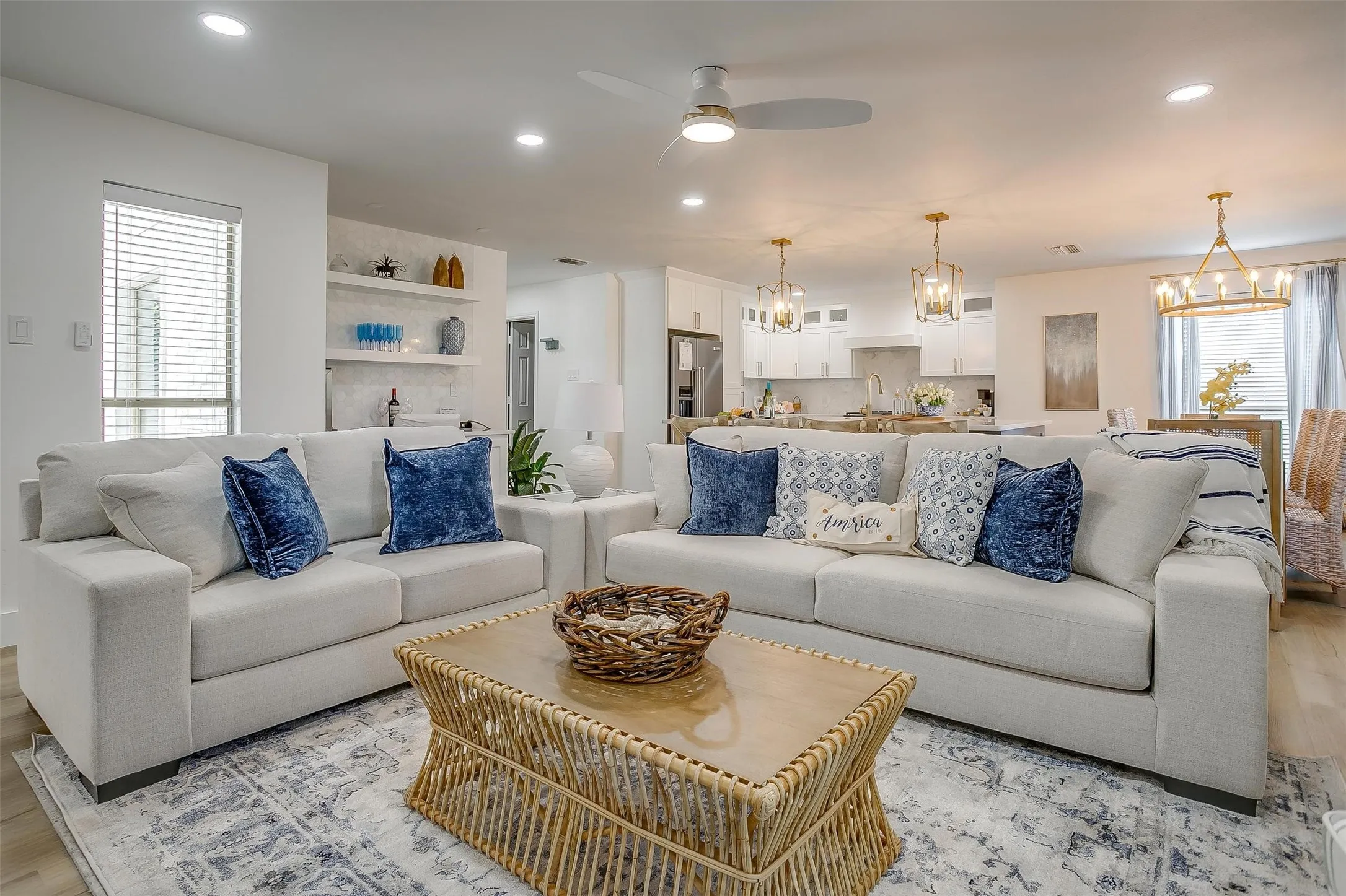 Open-concept living area featuring recessed lighting, a ceiling fan, and light wood-finish flooring