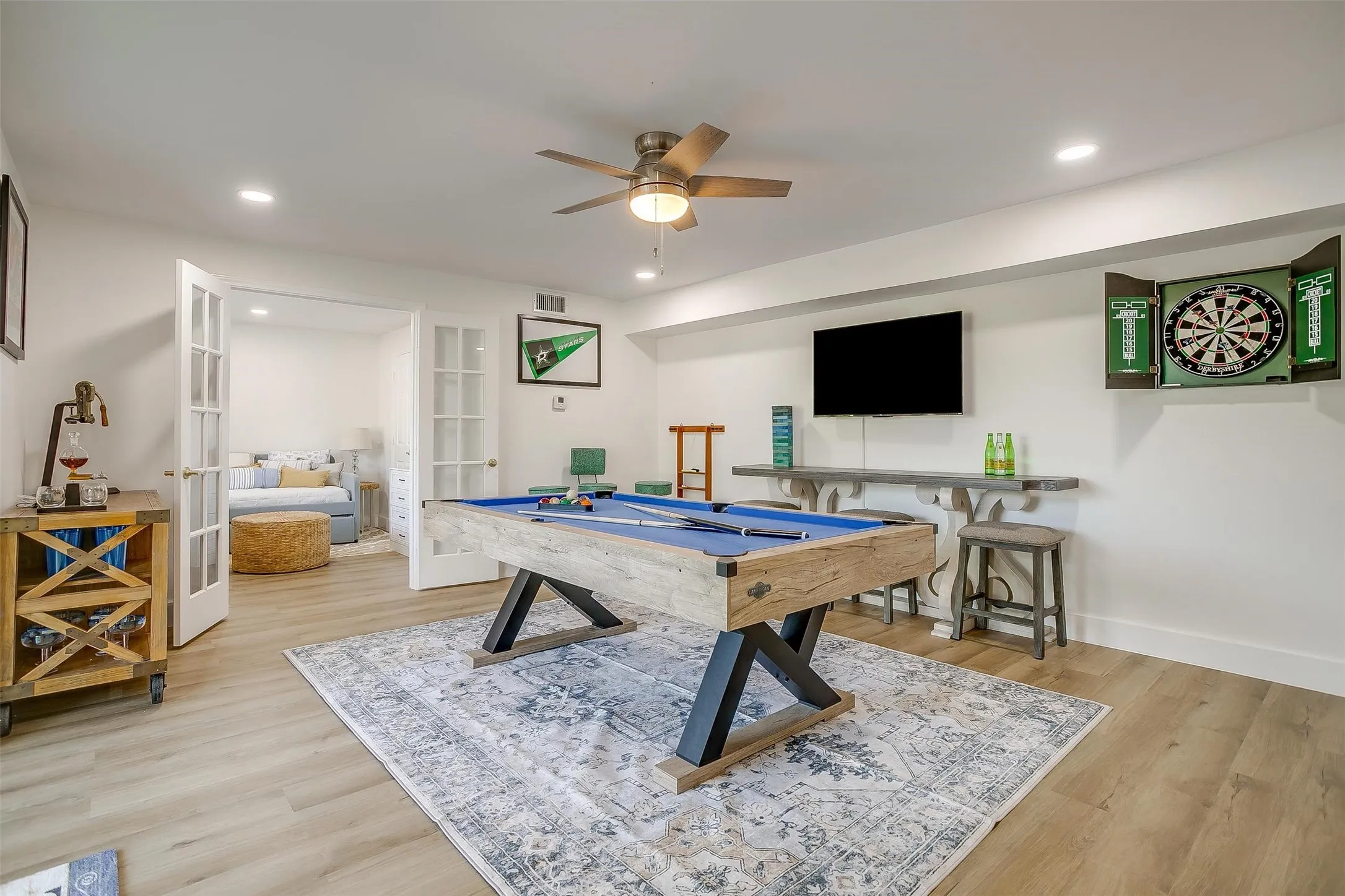 Spacious recreational room featuring wood-finish flooring and recessed lighting