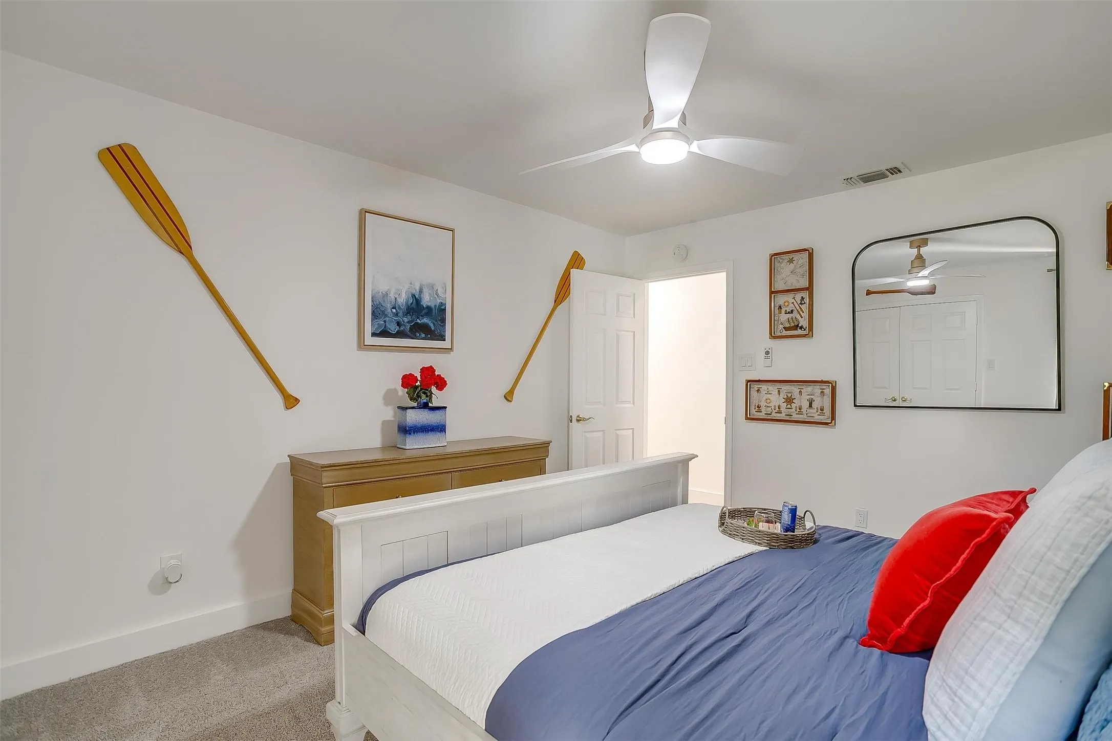 White walls and gray carpet flooring create a neutral palette for this room