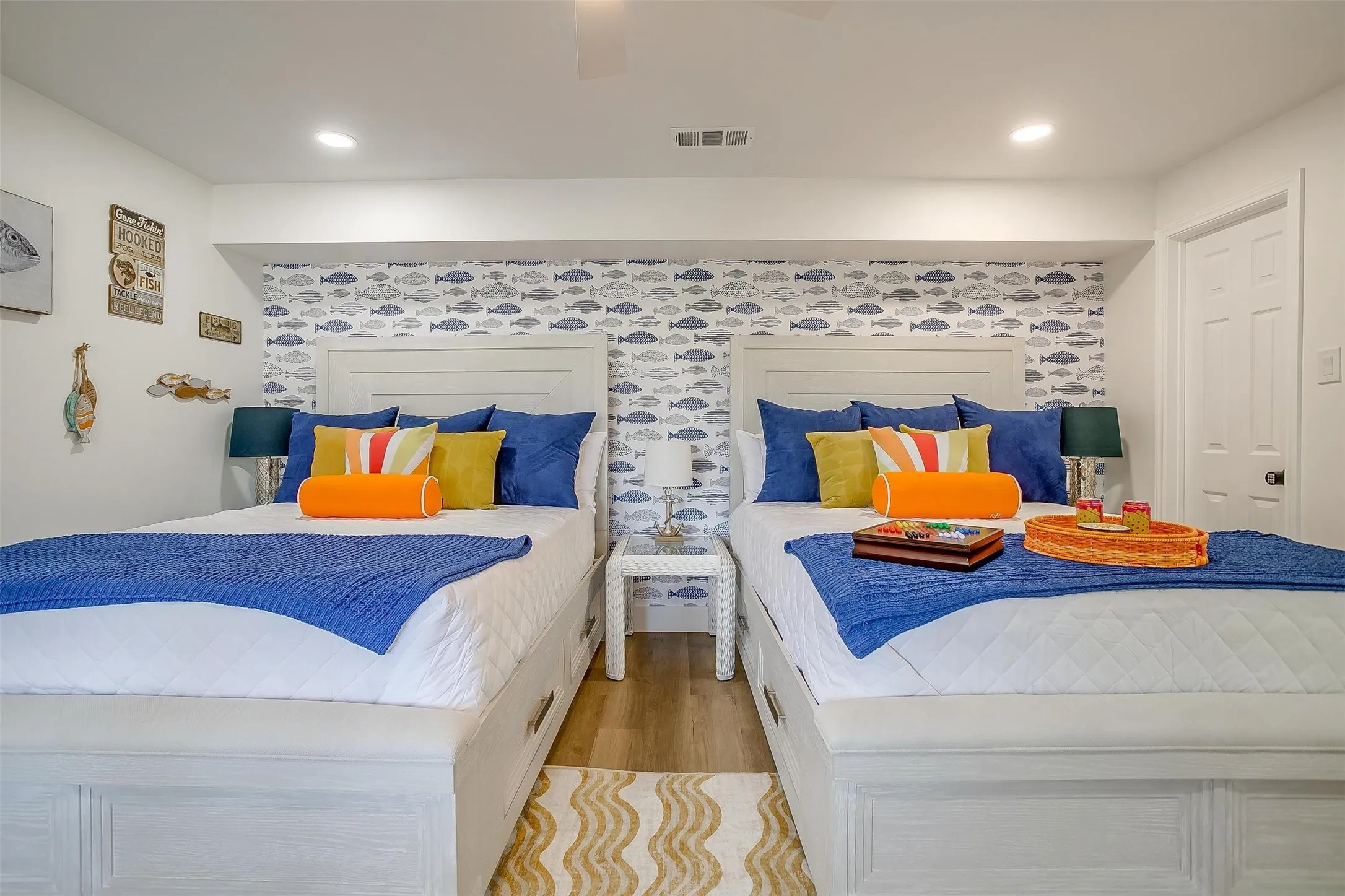 Bedroom featuring two platform beds with headboards and integrated storage drawers