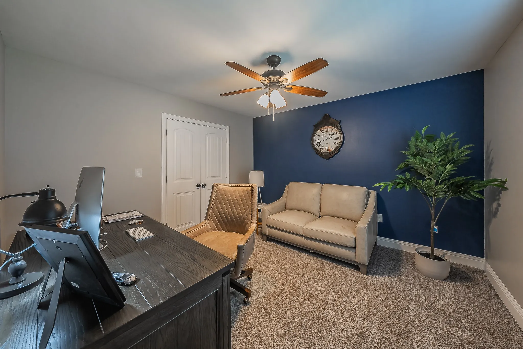 Versatile interior space featuring carpeting and a rich blue accent wall