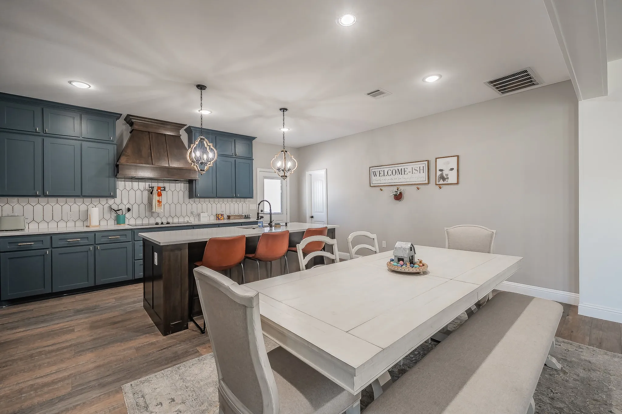Open-concept kitchen and dining area featuring wood-finish flooring