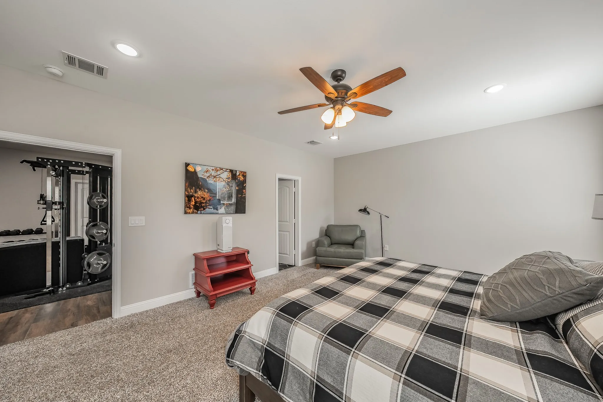 Carpeted room with recessed lighting and a ceiling fan