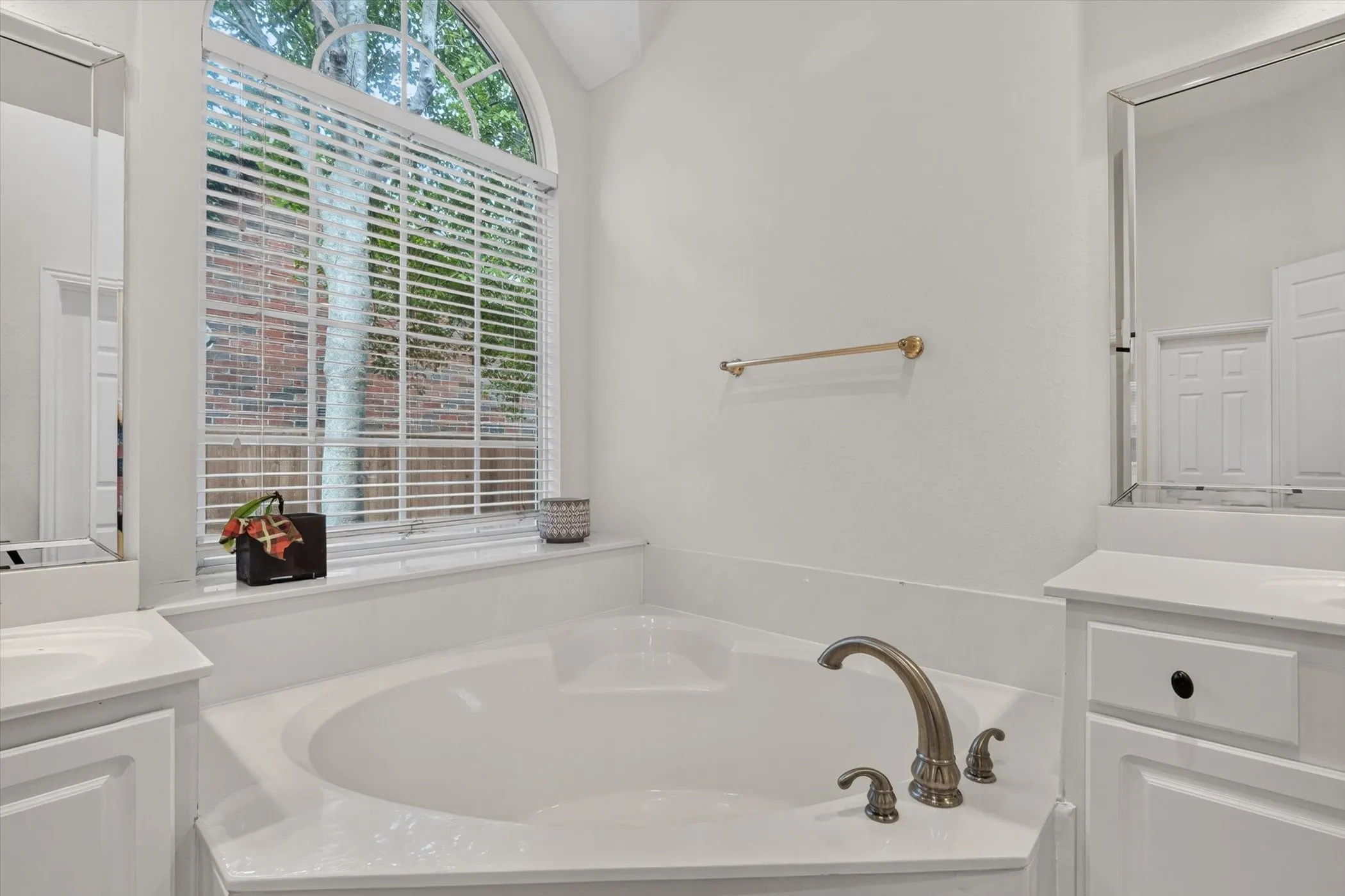 Corner soaking tub with bronze-finish fixtures
