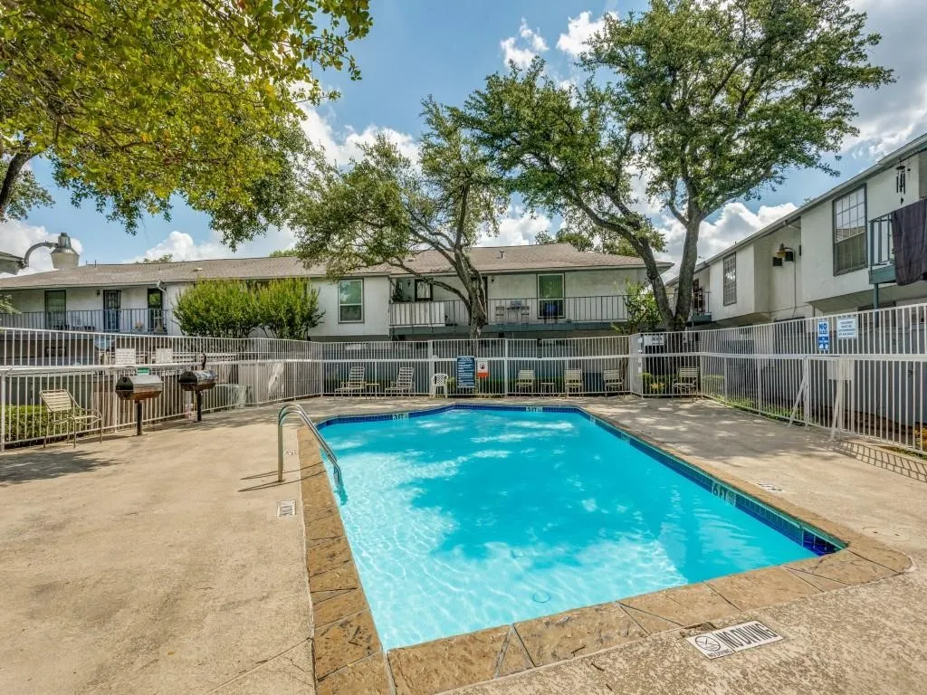 Rectangular swimming pool with a concrete surround and textured coping