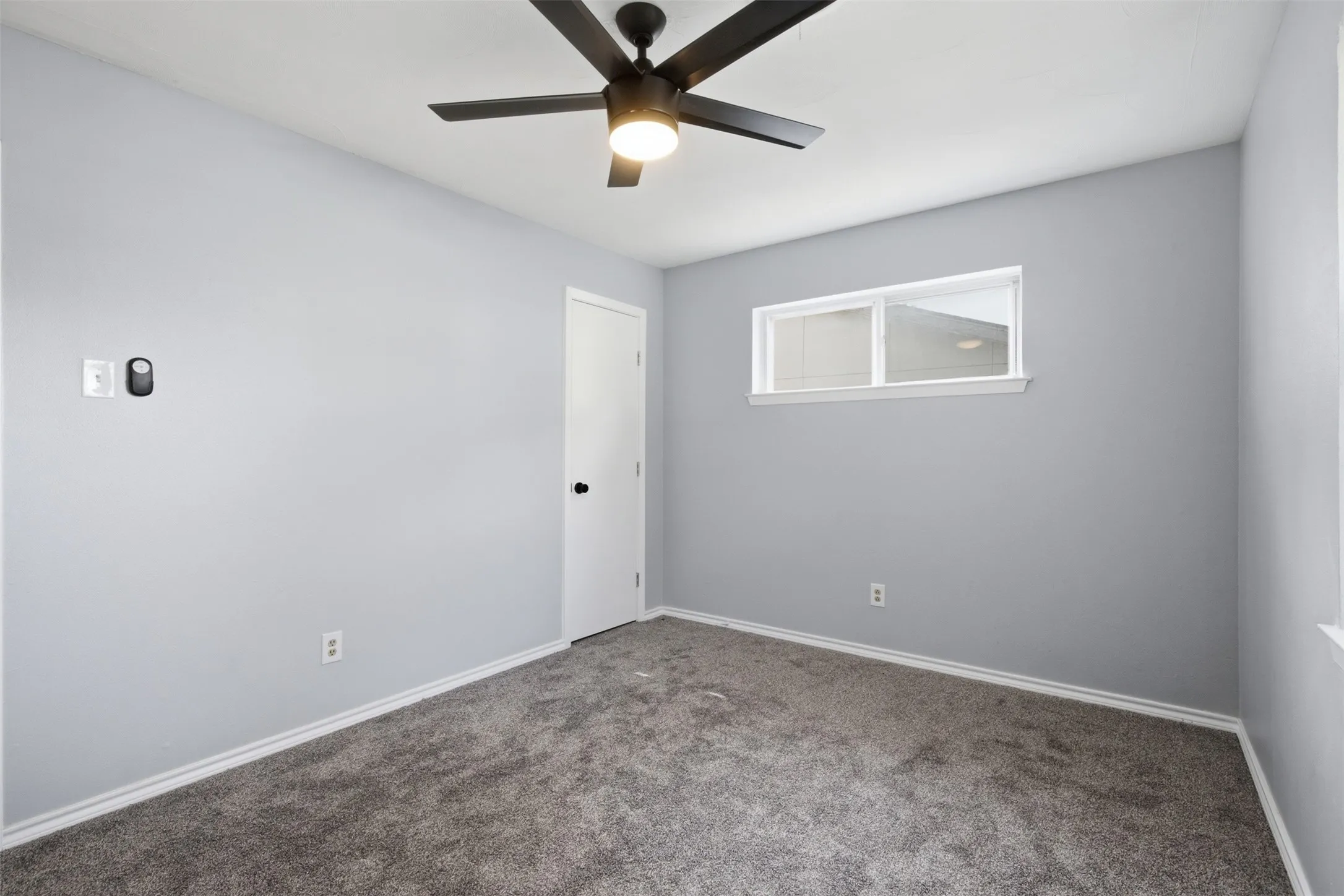 A Calm and Private Escape — Positioned on the first floor, the primary bedroom offers a comfortable separation from the two upstairs bedrooms and convenient access to the remodeled bath.