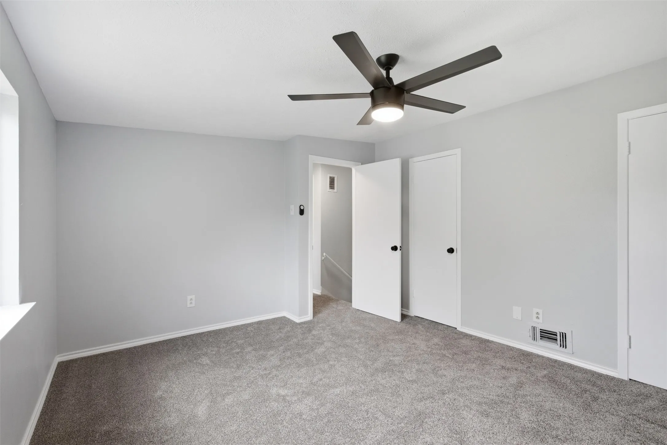 Flexible Layout with Storage — This secondary bedroom offers generous wall space, a dedicated closet, and a versatile footprint that can easily support sleeping, working, or creative use.