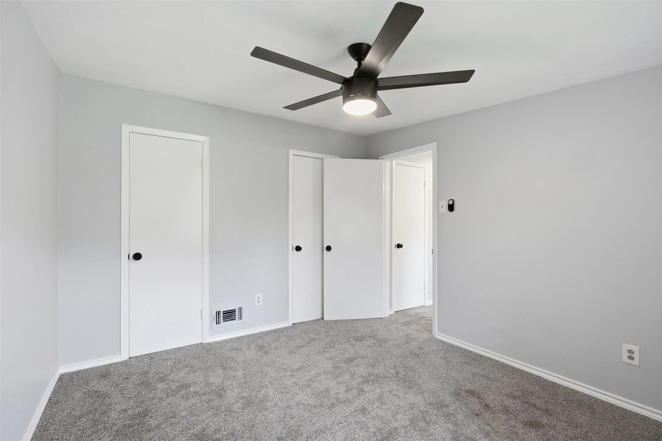 Flexible Space with Ample Storage — This upstairs bedroom offers generous wall space, multiple closets, and a versatile footprint that can adapt to sleeping, working, or hobby needs.