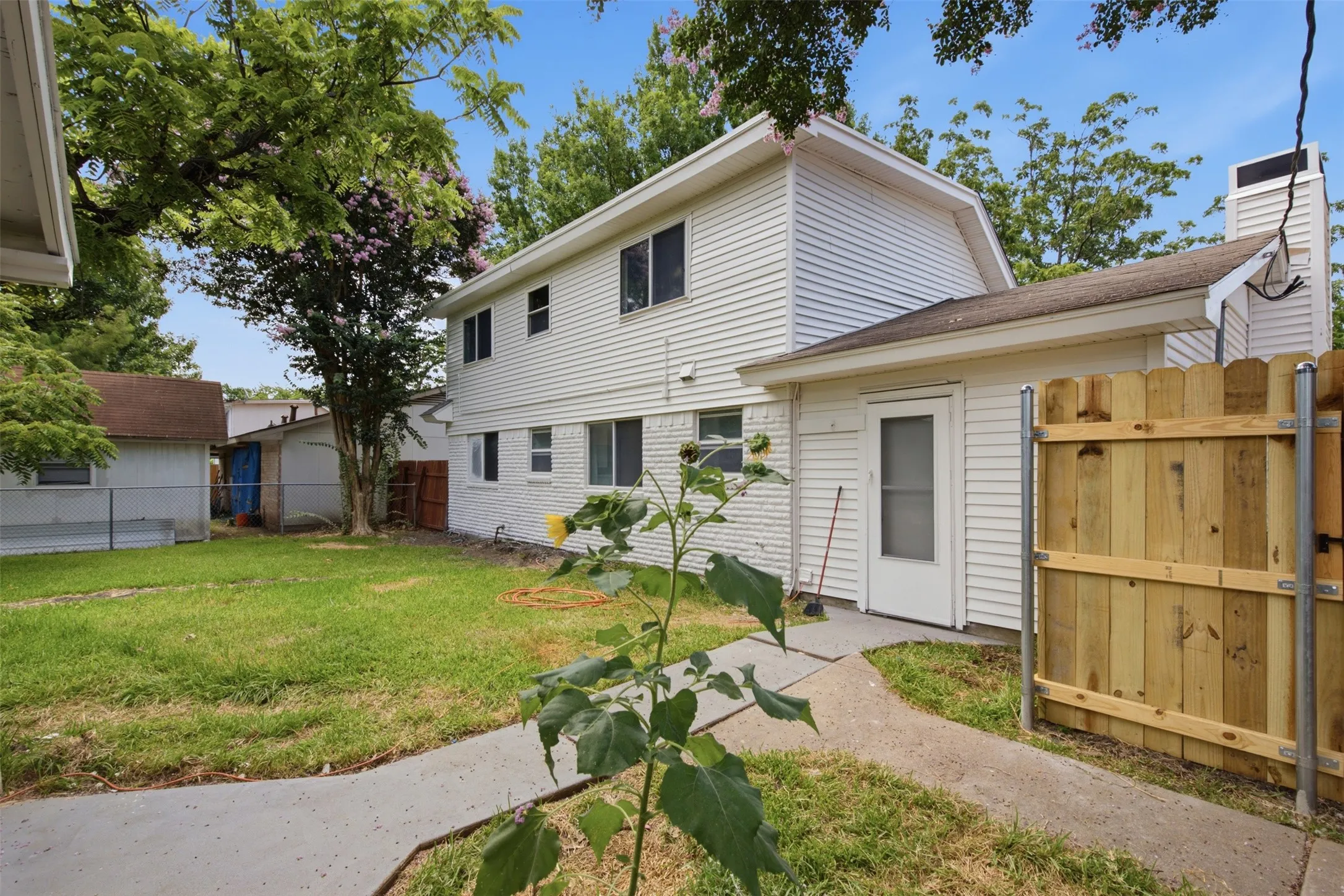 Easy Backyard Access — A rear entry opens directly to the backyard, creating a practical connection between the interior and the home’s outdoor spaces.