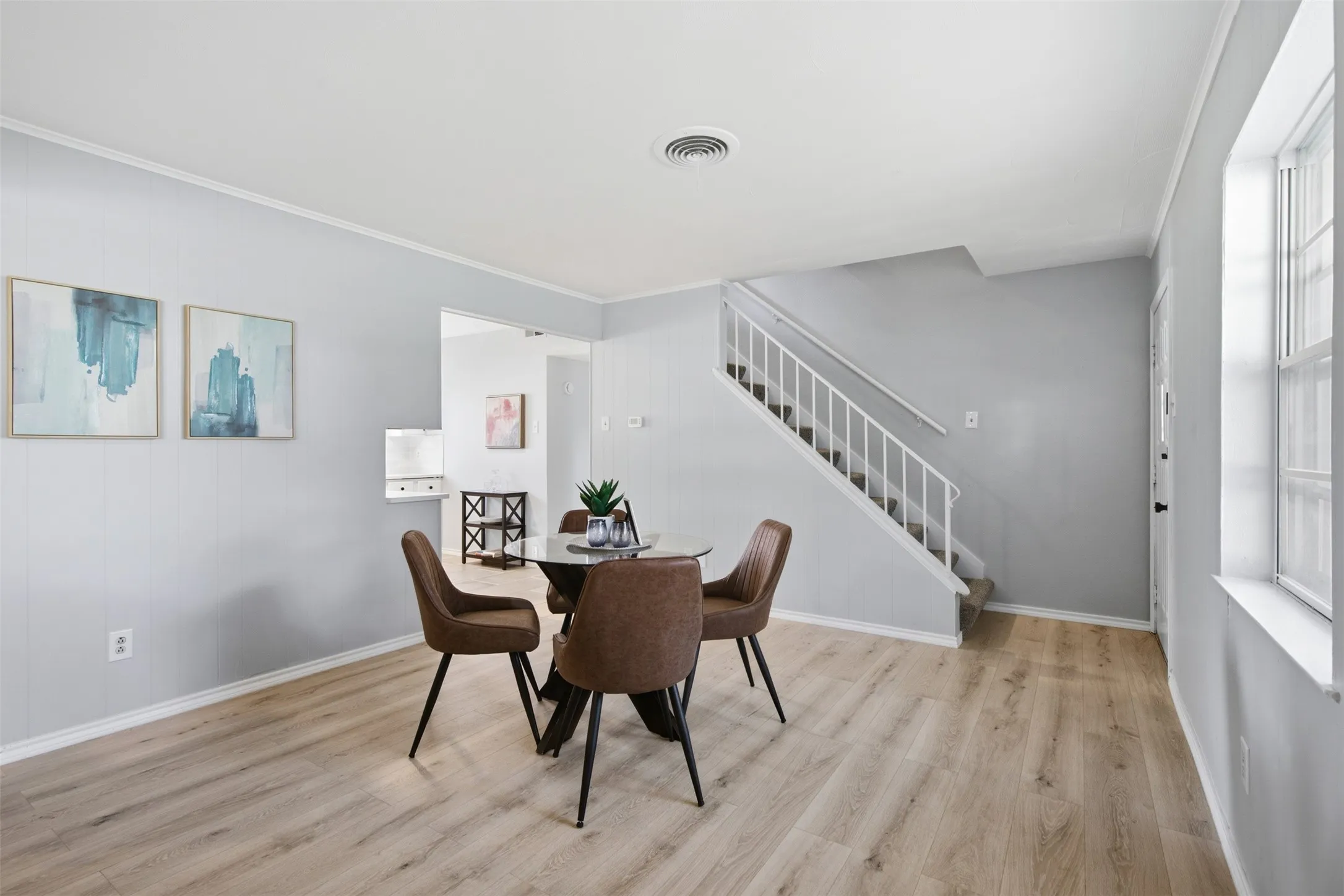 Flexible Main-Level Layout — The spacious dining area connects naturally to the kitchen, staircase, and front entry, offering a functional central gathering space with room to make it your own.