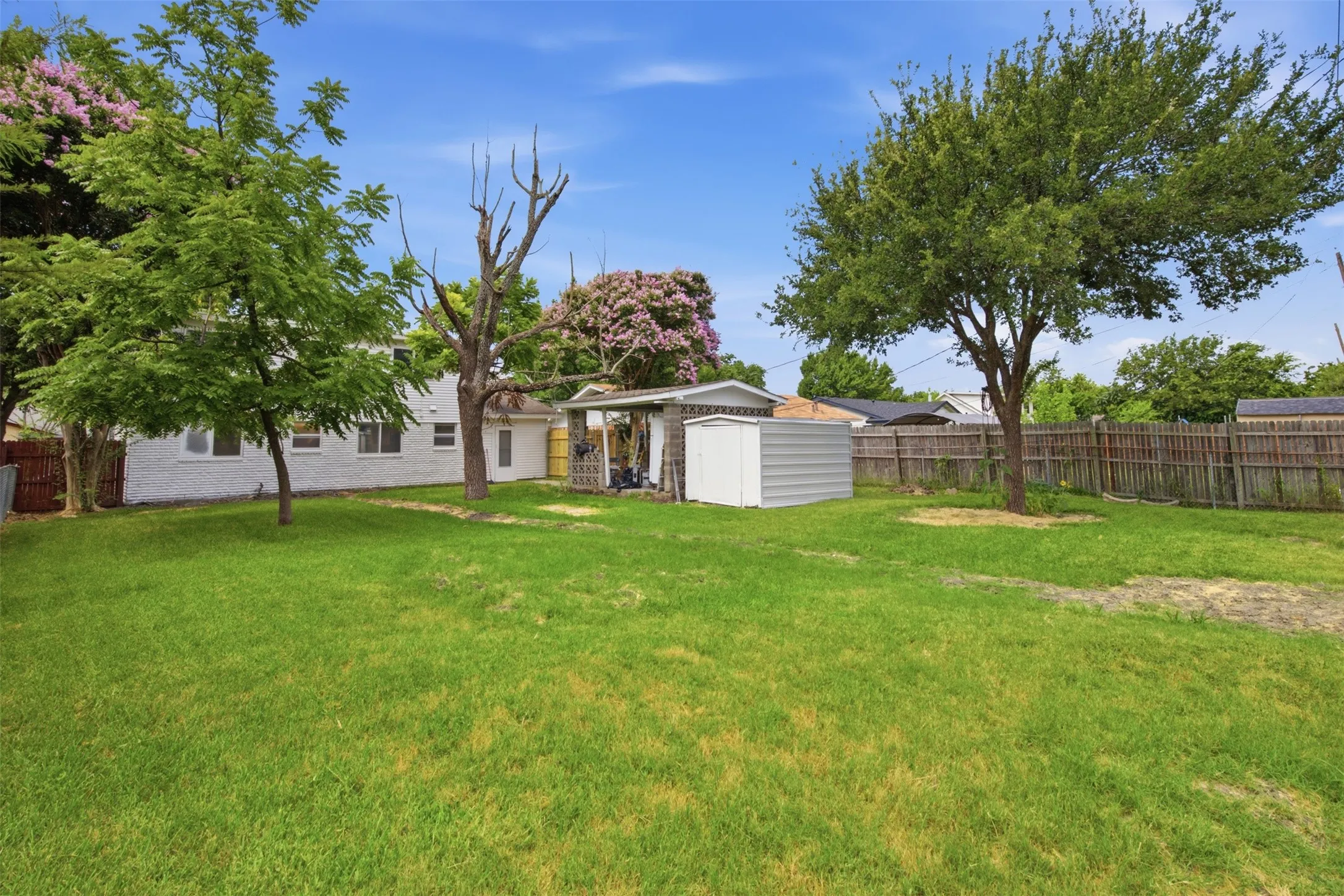 Room to Relax Outdoors — The large backyard offers plenty of open lawn for gardening, recreation, or future outdoor living, all beneath the shade of established trees.