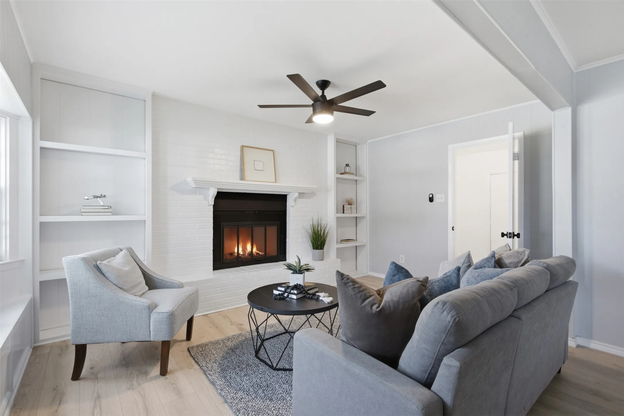 Character Meets Comfort — Built-ins surrounding the fireplace add practical display and storage space, while the room’s generous proportions make it easy to arrange for conversation or relaxation.