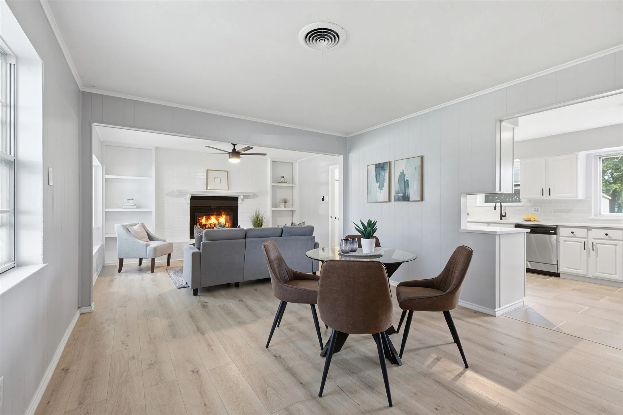 Open, Connected Living — New LVP flooring carries through the dining and living areas, while wide openings and a kitchen pass-through create easy sightlines for everyday living and entertaining.